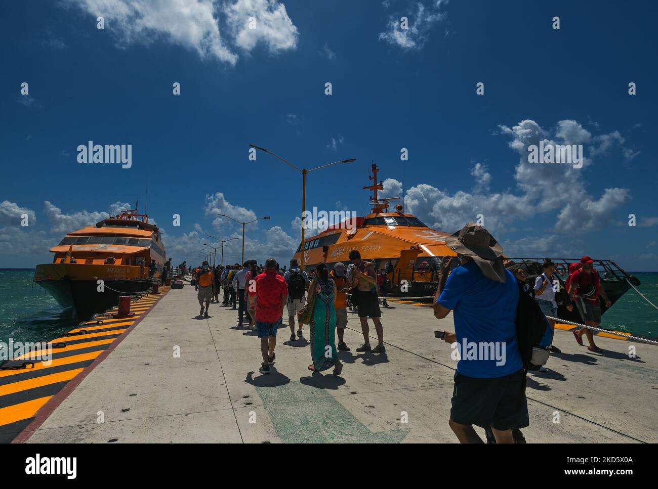 Passengers arrive at the Playa del Carmen ferry terminal to board the