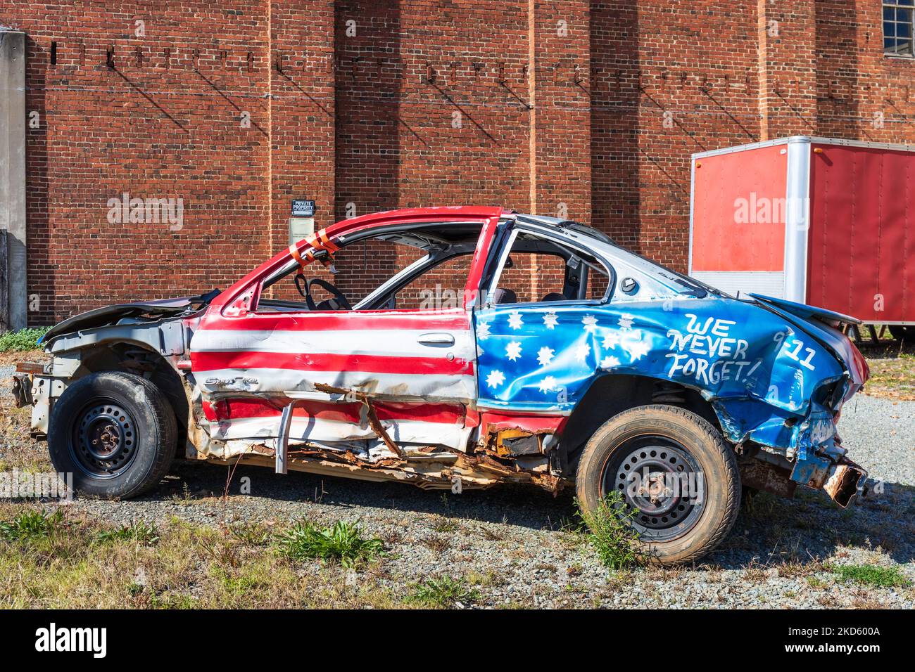 GALAX, VIRGINIA, USA-15 OCTOBER 2022: Compact car painted as American flag, and badly wrecked, with message 'We Never Forget! 9-11' painted on fender. Stock Photo
