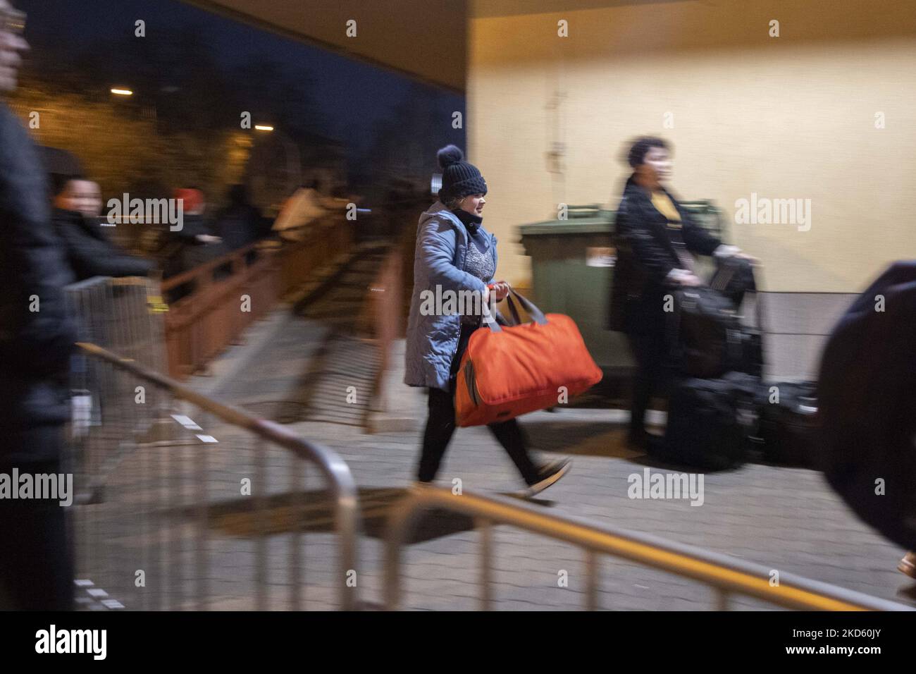 A girl holds her luggage while she arrives at Przemysl railway station