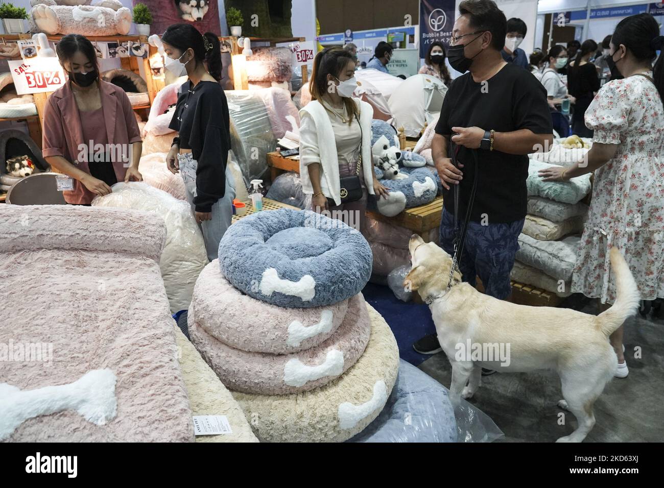 People looks at dog product for sale at the Thailand International Pet