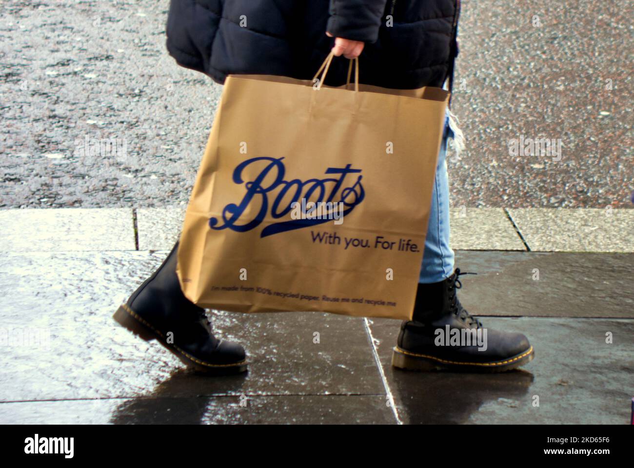 boots the chemist bag walking customer in boots close up Stock Photo
