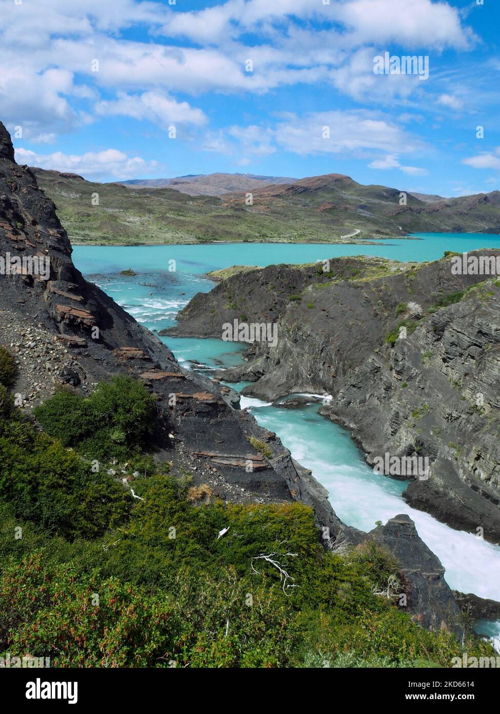 A vertical shot of the Paine river with rocky shore Stock Photo