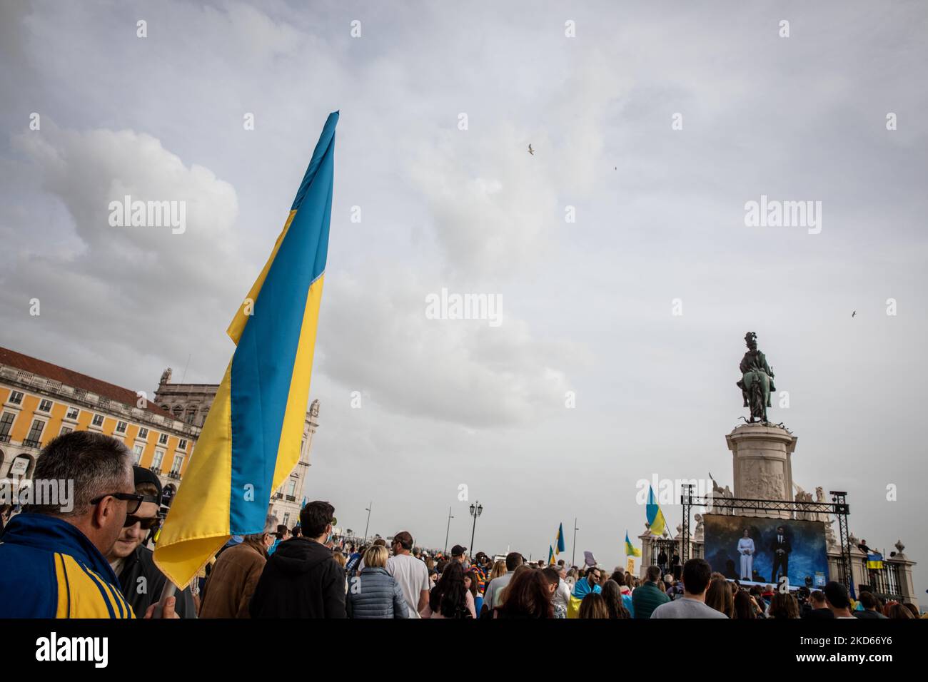 An Ukrainian flag (Ukraine National Flag) is seen in Praca do Comercio, in Lisbon, Portugal during a demonstration to show solidarity with the people of that country following the Russian invasion on March 27, 2022. - More than 3.8 million people have fled Ukraine since Russia's invasion a month ago, UN figures showed on March 27, but the flow of refugees has slowed down markedly. The UN refugee agency, UNHCR, said 3,821,049 Ukrainians had fled the country -- an increase of 48,450 from the figures of March 26. (Photo by Manuel Romano/NurPhoto) Stock Photo