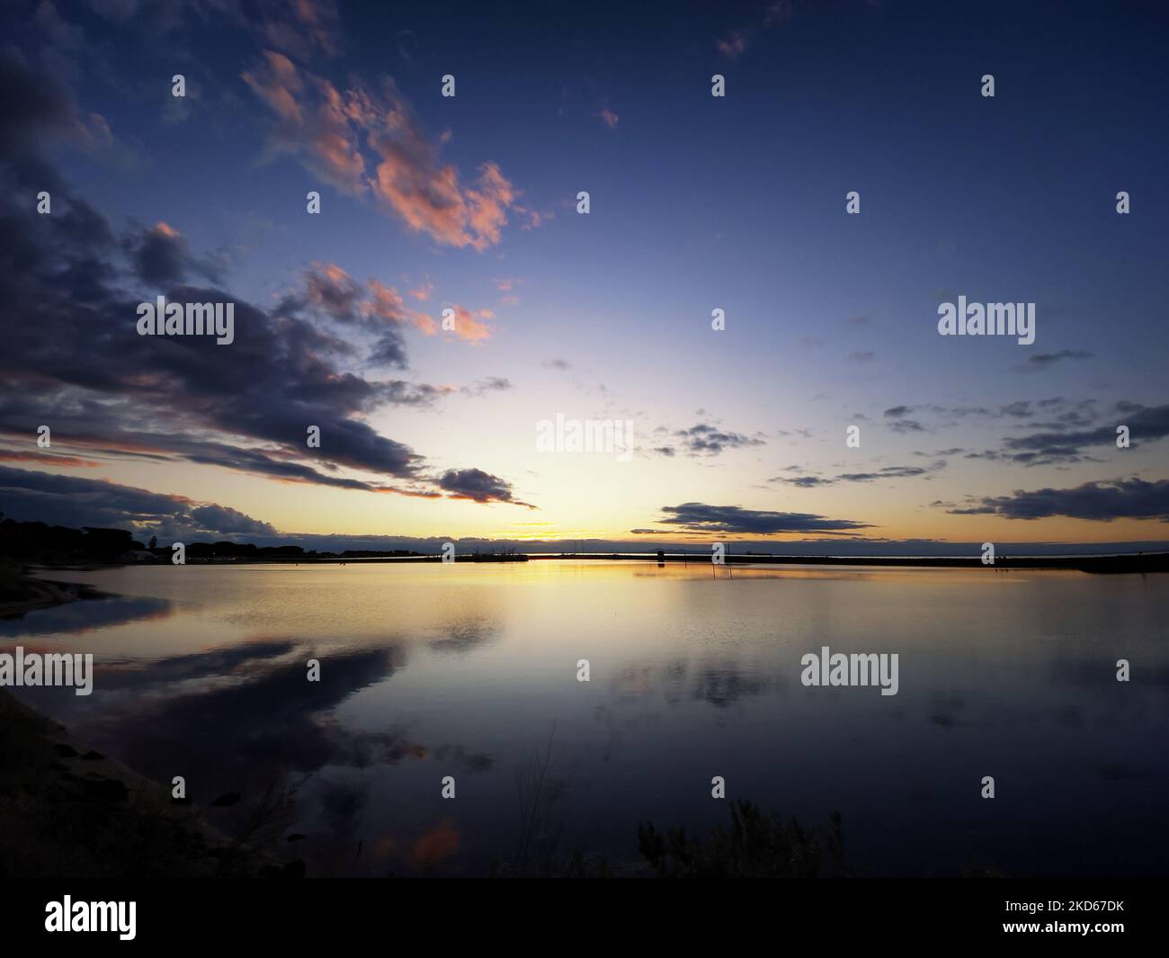 Magical sunset reflecting clouds hi-res stock photography and images ...
