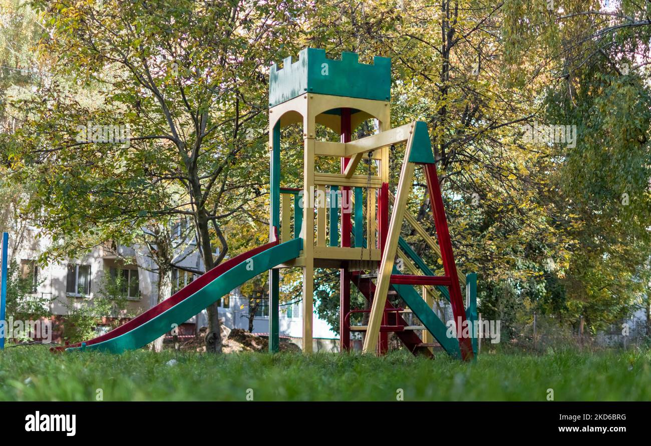Bright multicolored playground in courtyard of multistorey buildings