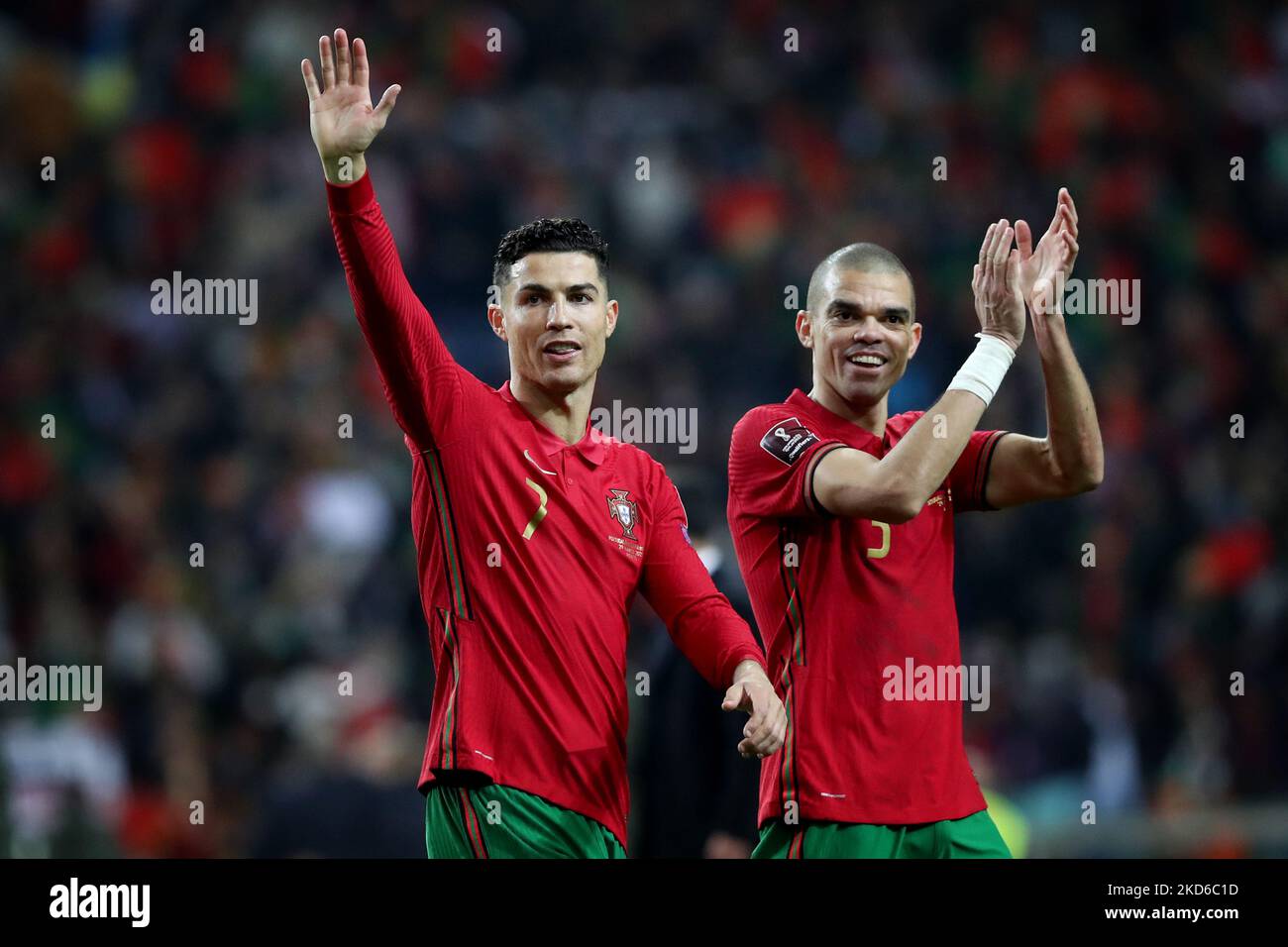 Portugal's forward Cristiano Ronaldo (L) and Pepe celebrate the victory at the end of the 2022 FIFA World Cup Qualifier football match between Portugal and North Macedonia at the Dragao stadium in Porto, Portugal, on March 29, 2022. (Photo by Pedro FiÃºza/NurPhoto) Stock Photo