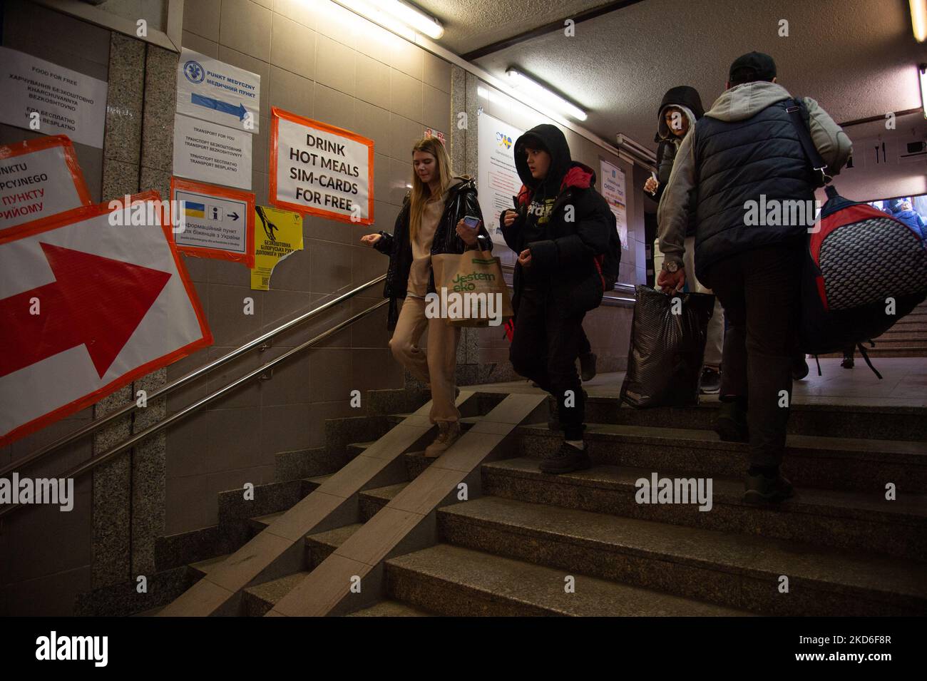 Ukrainian refugees who have just got off the train arrive in Poland