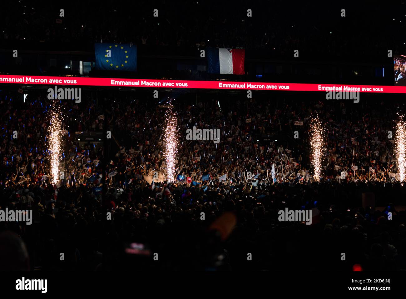 Fireworks are lit as French President and candidate for his own re-election from the liberal La République en Marche (LREM) party, Emmanuel Macron, arrives for his first campaign rally held at the U Arena in Paris La Défense in front of several thousand supporters and members of his government, in the Paris suburb of Nanterre, April 2, 2022. (Photo by Samuel Boivin/NurPhoto) Stock Photo