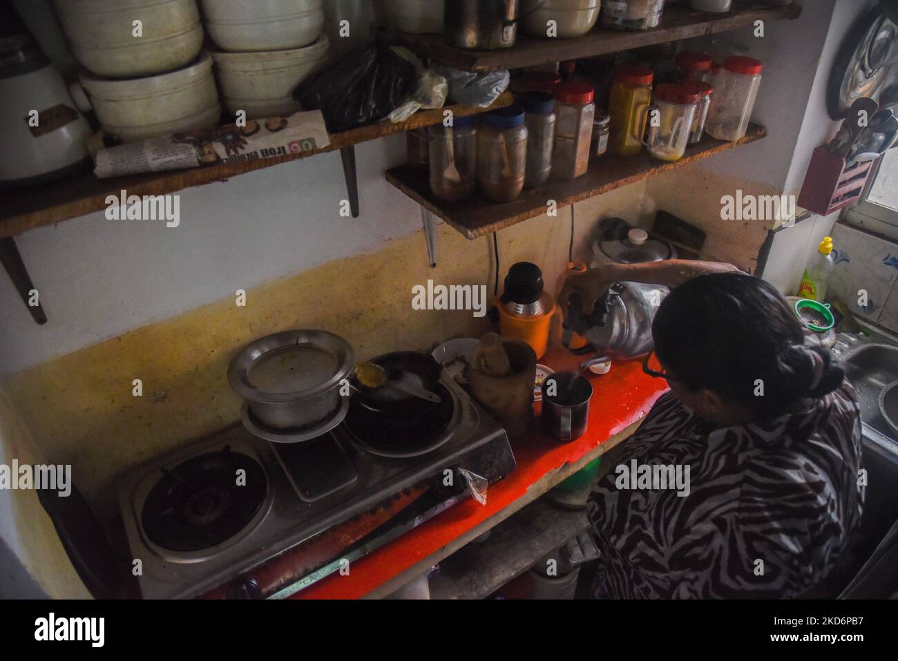 : A woman making tea in her kitchen in Colombo. Essential commodities such as milk powder and domestic gas cylinders have become scarce in the country as a result of import restrictions following the forex crisis Sri Lanka is currently facing on April 3, 2022 (Photo by Akila Jayawardana/NurPhoto) Stock Photo
