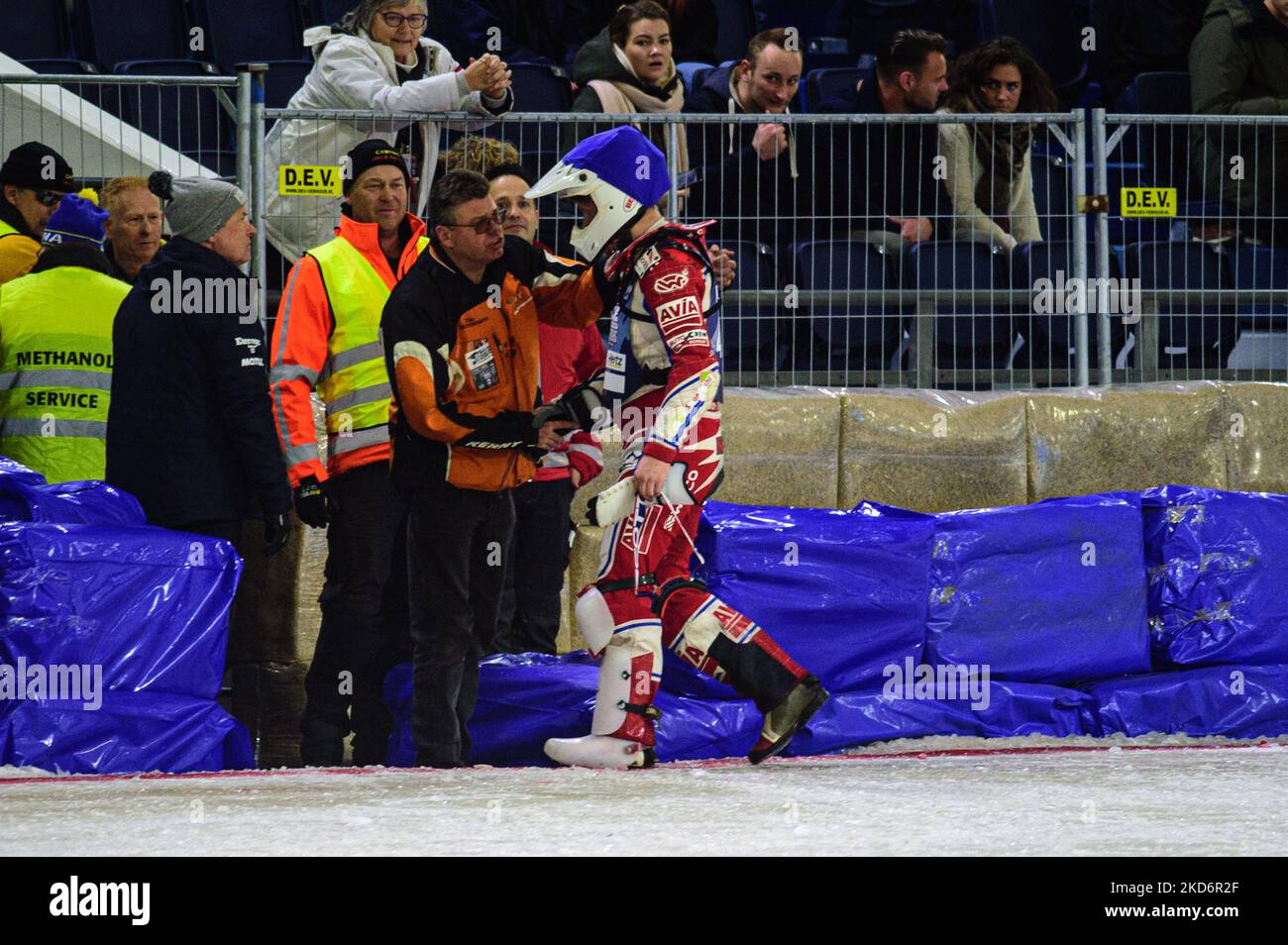 Niek Schaap (412) walks into the pits after his fall during the FIM Ice