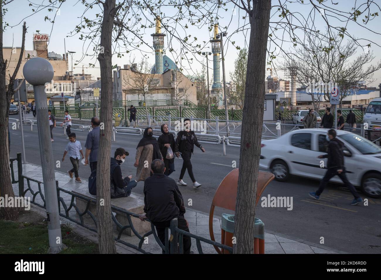 Iranians walk along a street near a holy shrine in northern Tehran on ...
