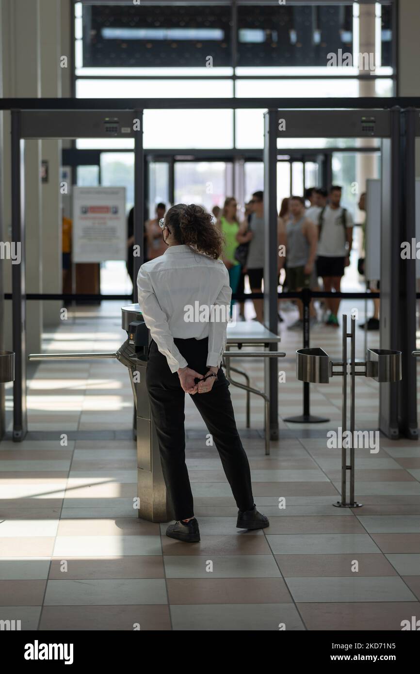 Security personnel checking bags and backpacks xrayed at the access