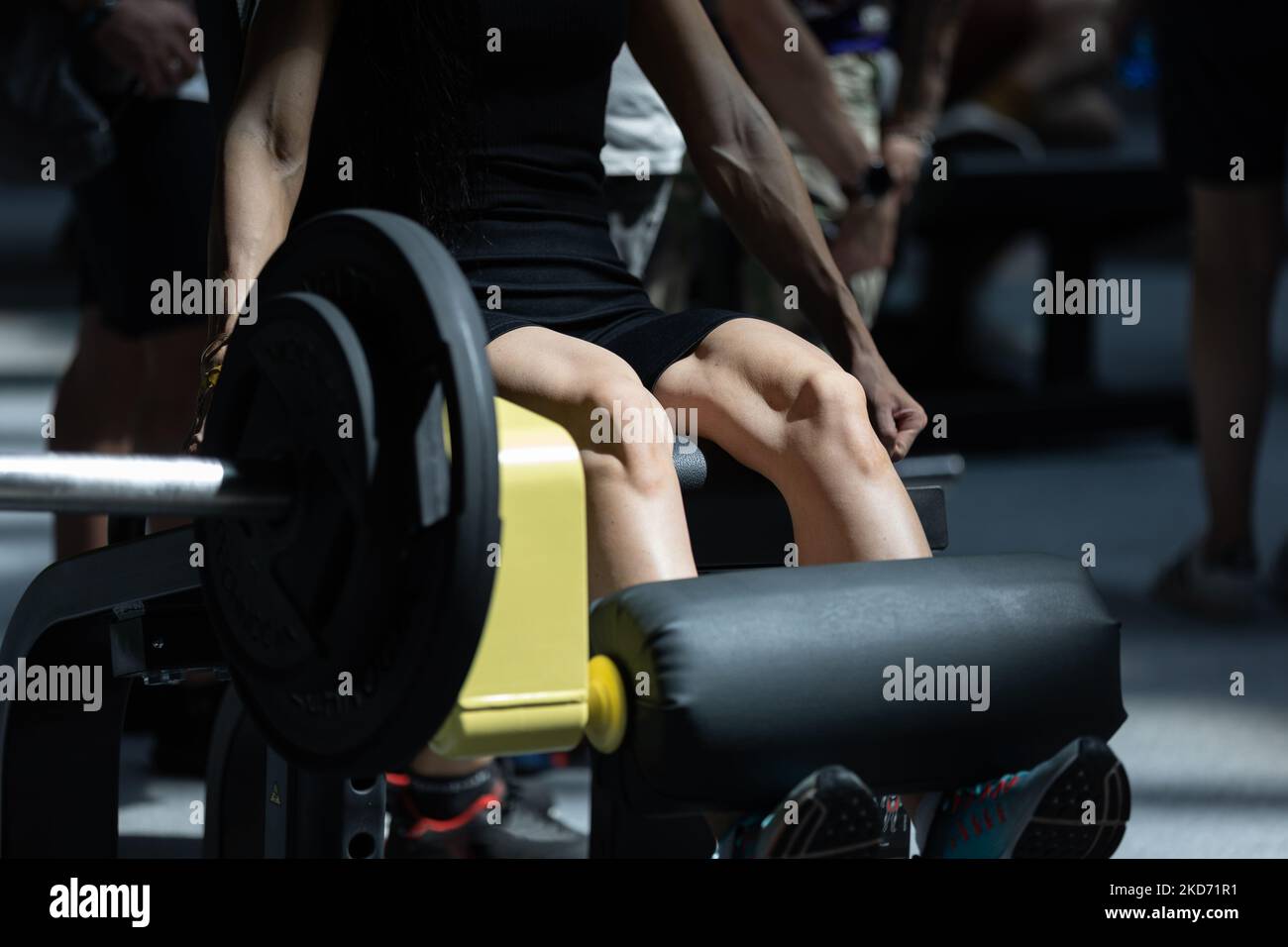 Girl Doing Exercises at Gym Leg Extensions Workout on Fitness Machine