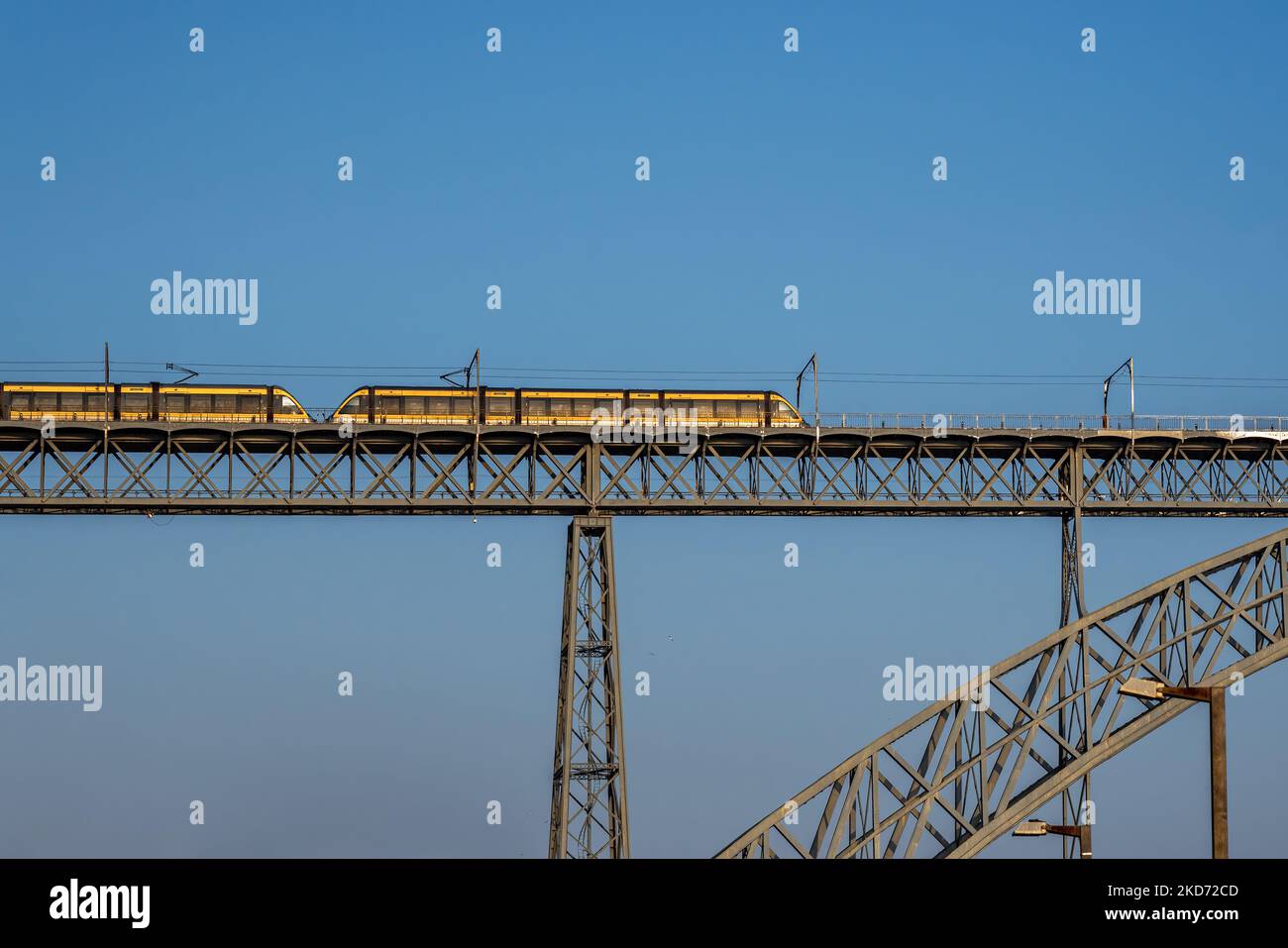 Yellow train at Dom Luis I Bridge - Porto, Portugal Stock Photo