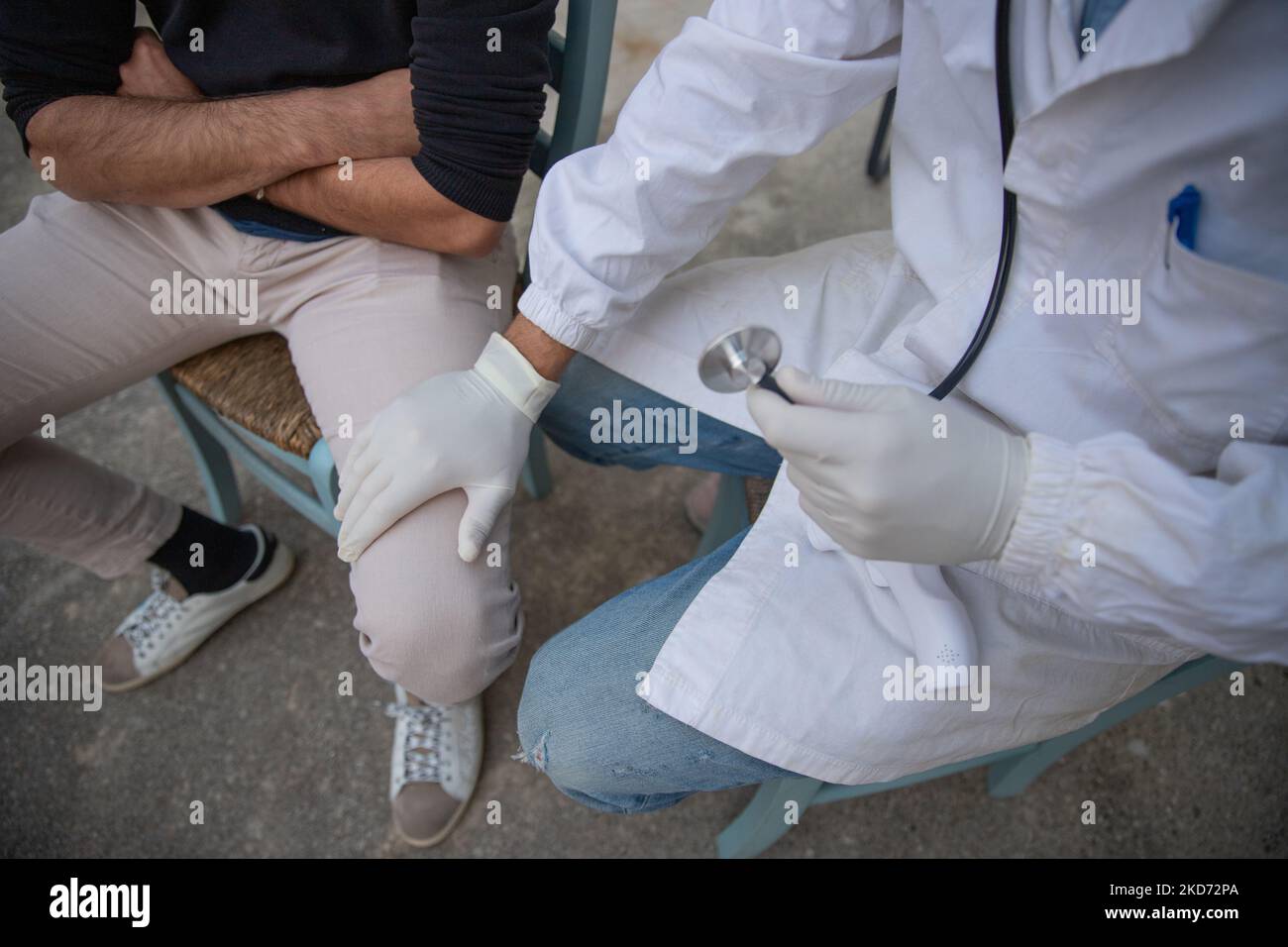 Healthcare worker calming his patient whom he is about to measure his pressure. Stock Photo