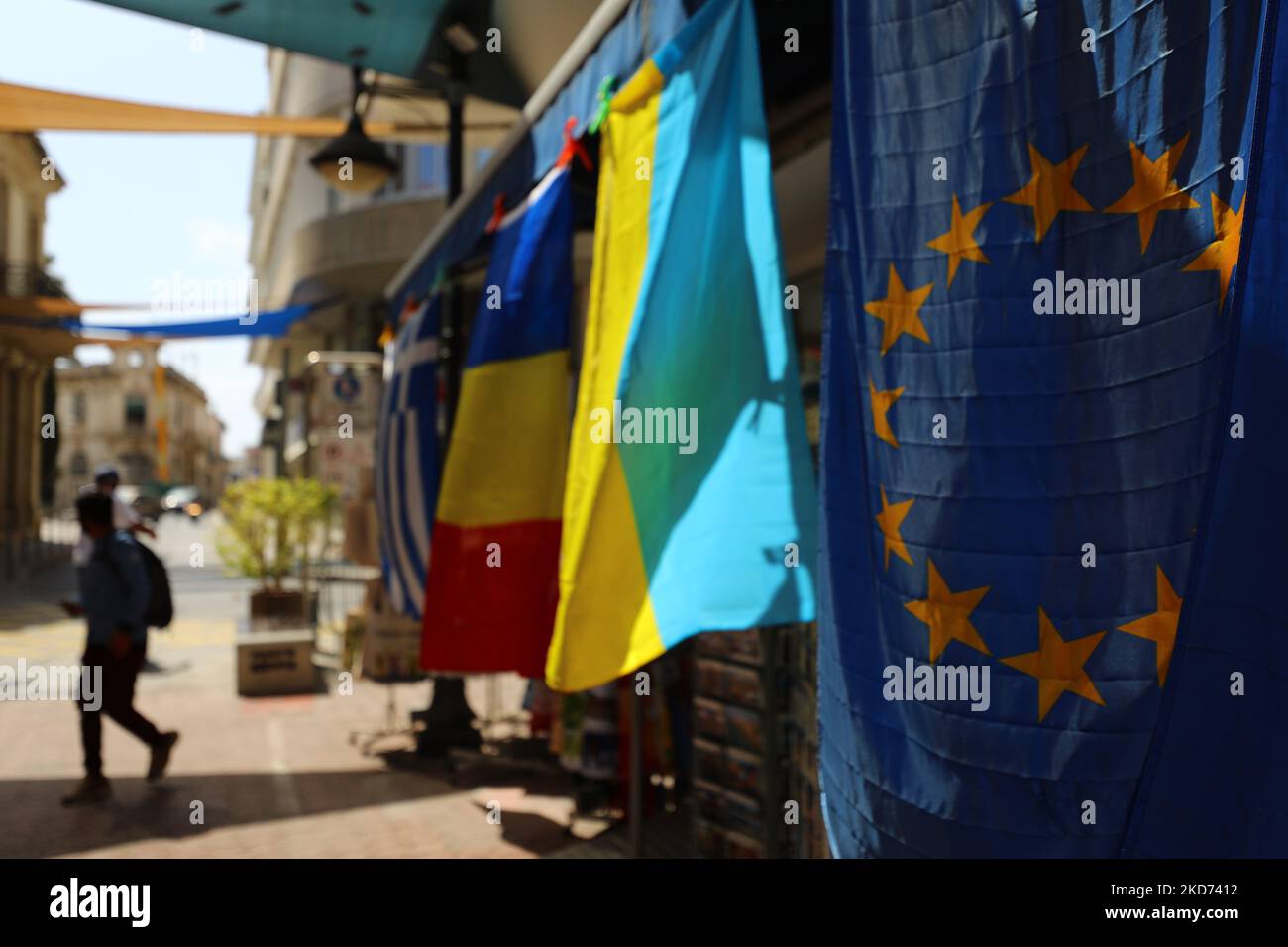 The flag of the European Union and the National flag of Ukraine are sold on a shopping street in the old area of the Mediterranean port of Limassol. Cyprus, Friday, April 8, 2022. Military operations in Ukraine could not but affect the tourism industry. Cyprus is expected to lose about 800,000 Russian and Ukrainian tourists this year, about 22% of the total expected tourist flow, which means that the industry could lose more than 500 million euros. (Photo by Danil Shamkin/NurPhoto) Stock Photo