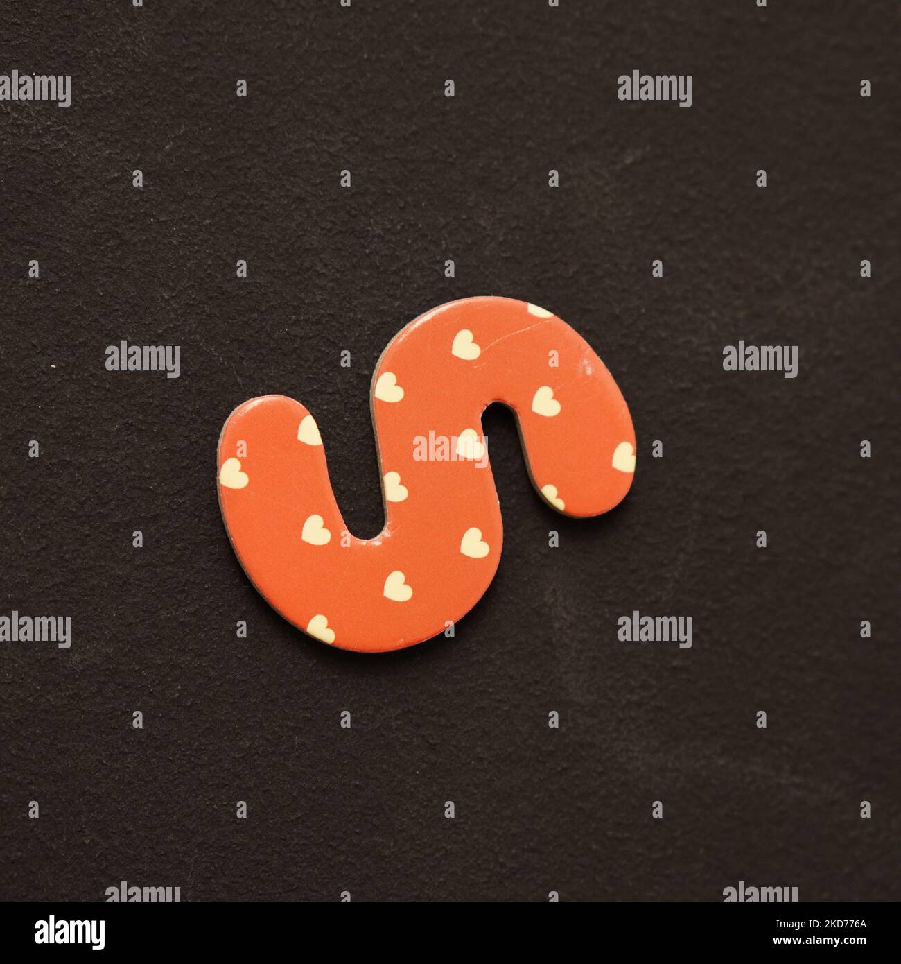 A red heart patterned S letter magnet on a black background Stock Photo ...