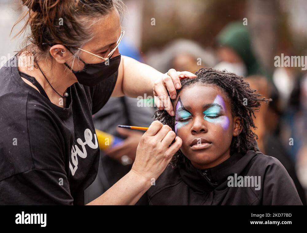 An artist paints a girl’s face during a block party celebrating the confirmation of Ketanji Brown Jackson to the Supreme Court. Justice Jackson will be the first Black woman and public defender to sit on the Court. The Senate voted 53-47 to confirm her on April 7, 2022. (Photo by Allison Bailey/NurPhoto) Stock Photo