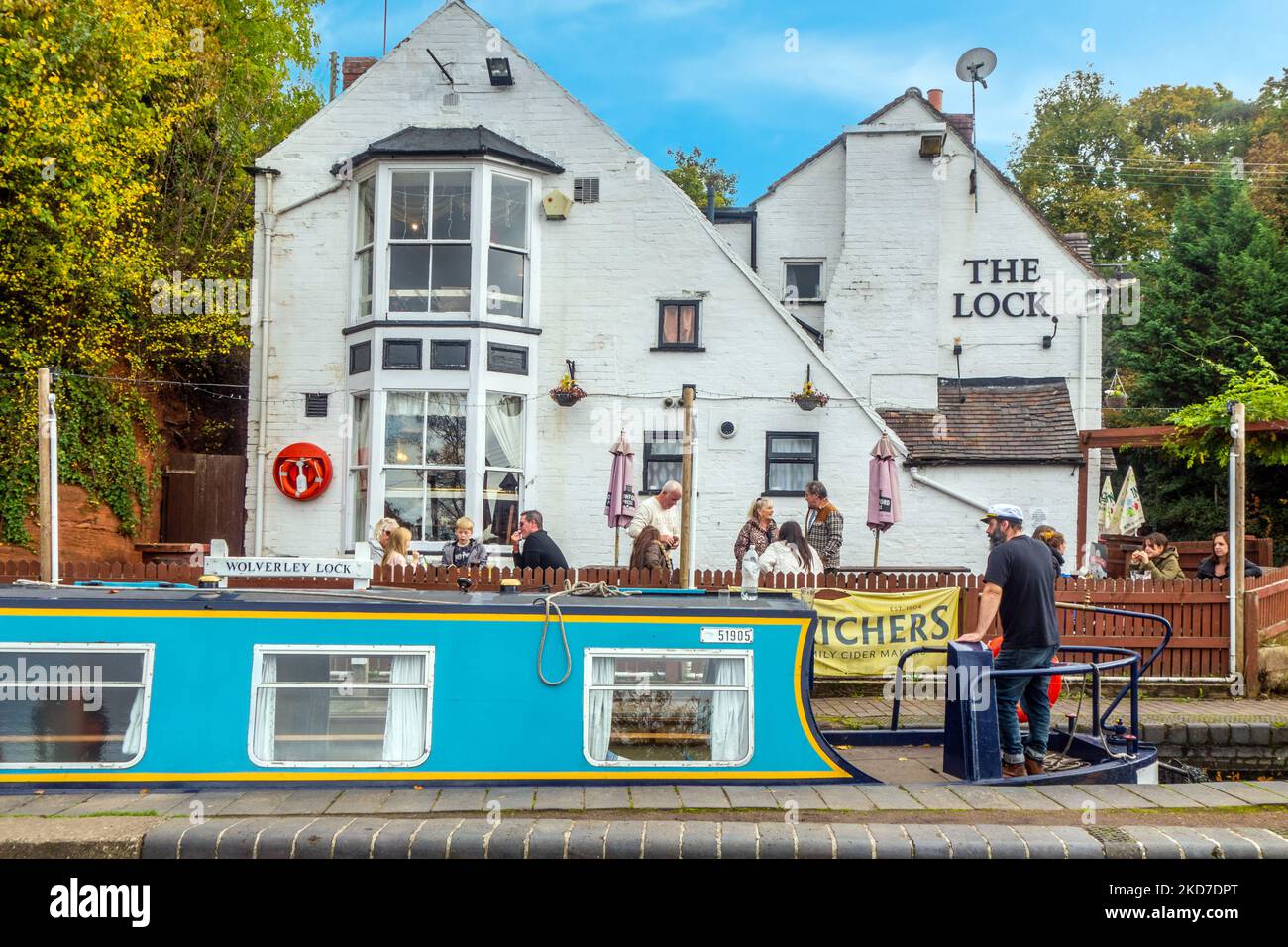 Canal Narrowboat on the Staffordshire and Worcester canal passing through the locks by the Lock inn pub in the Worcestershire village of Wolverley Stock Photo