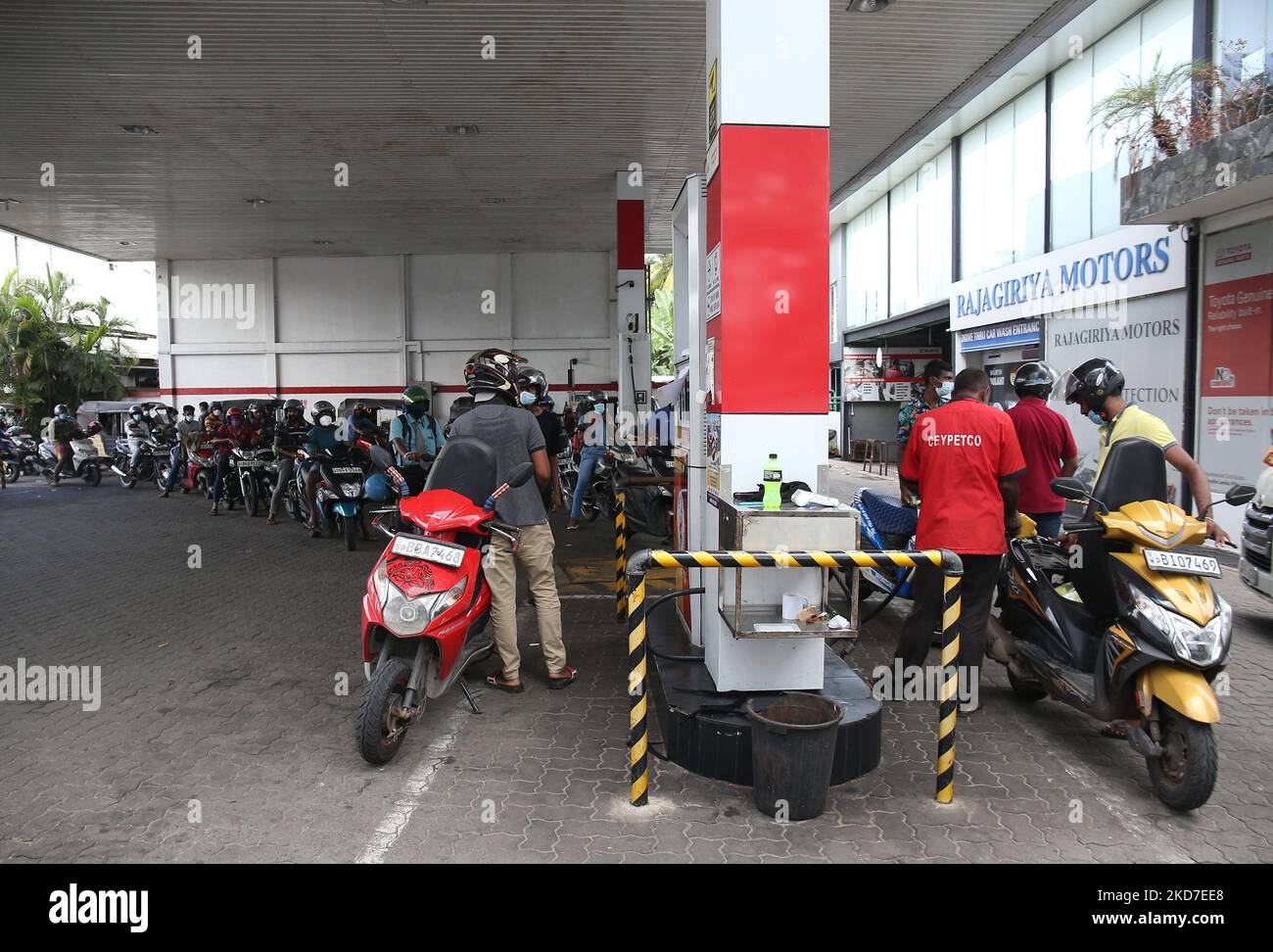 Motorists are queuing up to buy petrol at a petrol station Due to the