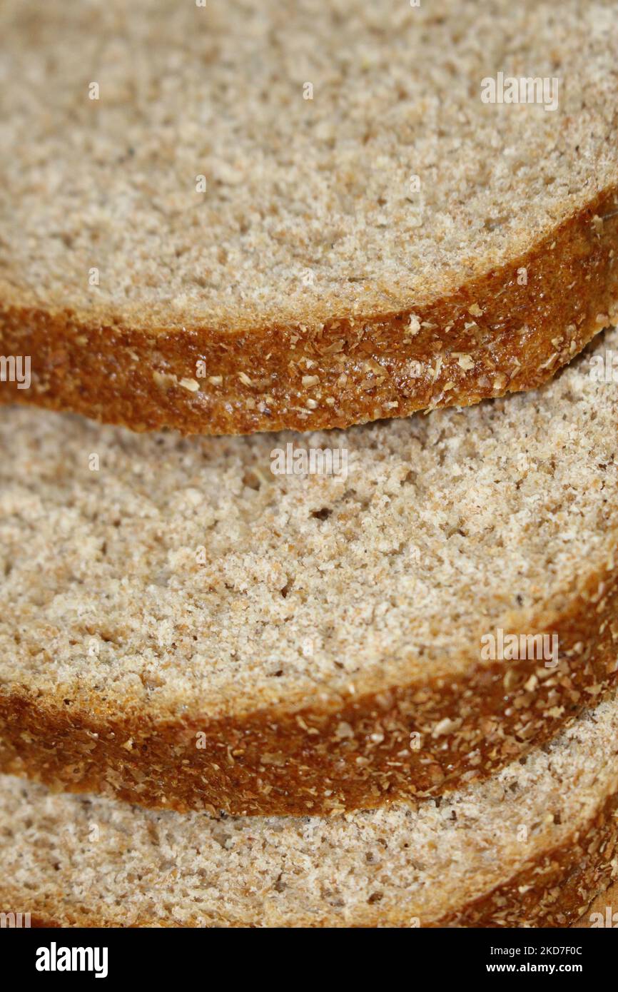 Macro close up of slices of wholewheat common bread offset from each other - whole health foods concept, healthy eating, sliced bread, morning toast, Stock Photo