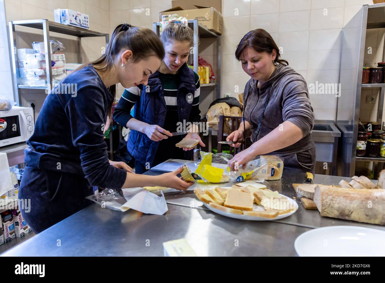 Ukrainian volunteers Krystyna, Maria and Mariana prepare breakfast for refugees who live in a house temporarily transferred into a shelter for women with children run by Greek-Catholich Church in Nadybym near Lviv, Ukraine on April 12, 2022. Since the Russian Federation invaded Ukraine, the conflict forced over 10 million people to flee their homes, both internally and externally. Many of the families in the centre come from the east of Ukraine. (Photo by Dominika Zarzycka/NurPhoto) Stock Photo
