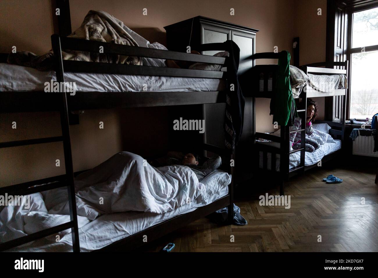 Families sleep in a house temporarily transferred into a shelter for women with children run by Greek-Catholich Church in Nadyby, near Lviv, Ukraine on April 12, 2022. Since the Russian Federation invaded Ukraine, the conflict forced over 10 million people to flee their homes, both internally and externally. Many of the families in the centre come from the east of Ukraine. (Photo by Dominika Zarzycka/NurPhoto) Stock Photo