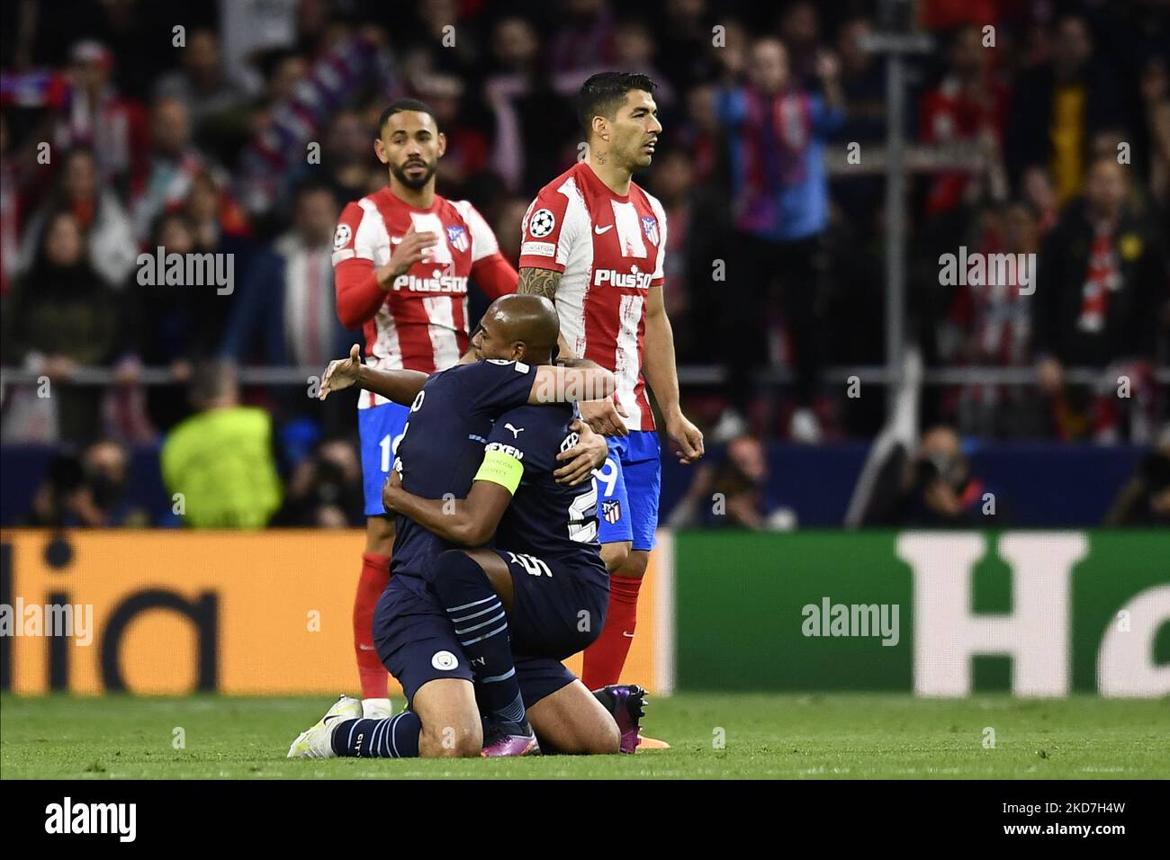 Rodri and Fernandinho of Manchester City celebrates victory and Luis Suarez of Atletico Madrid dejected after the UEFA Champions League Quarter Final Leg Two match between Atletico Madrid and Manchester City at Wanda Metropolitano on April 13, 2022 in Madrid, Spain. (Photo by Jose Breton/Pics Action/NurPhoto) Stock Photo