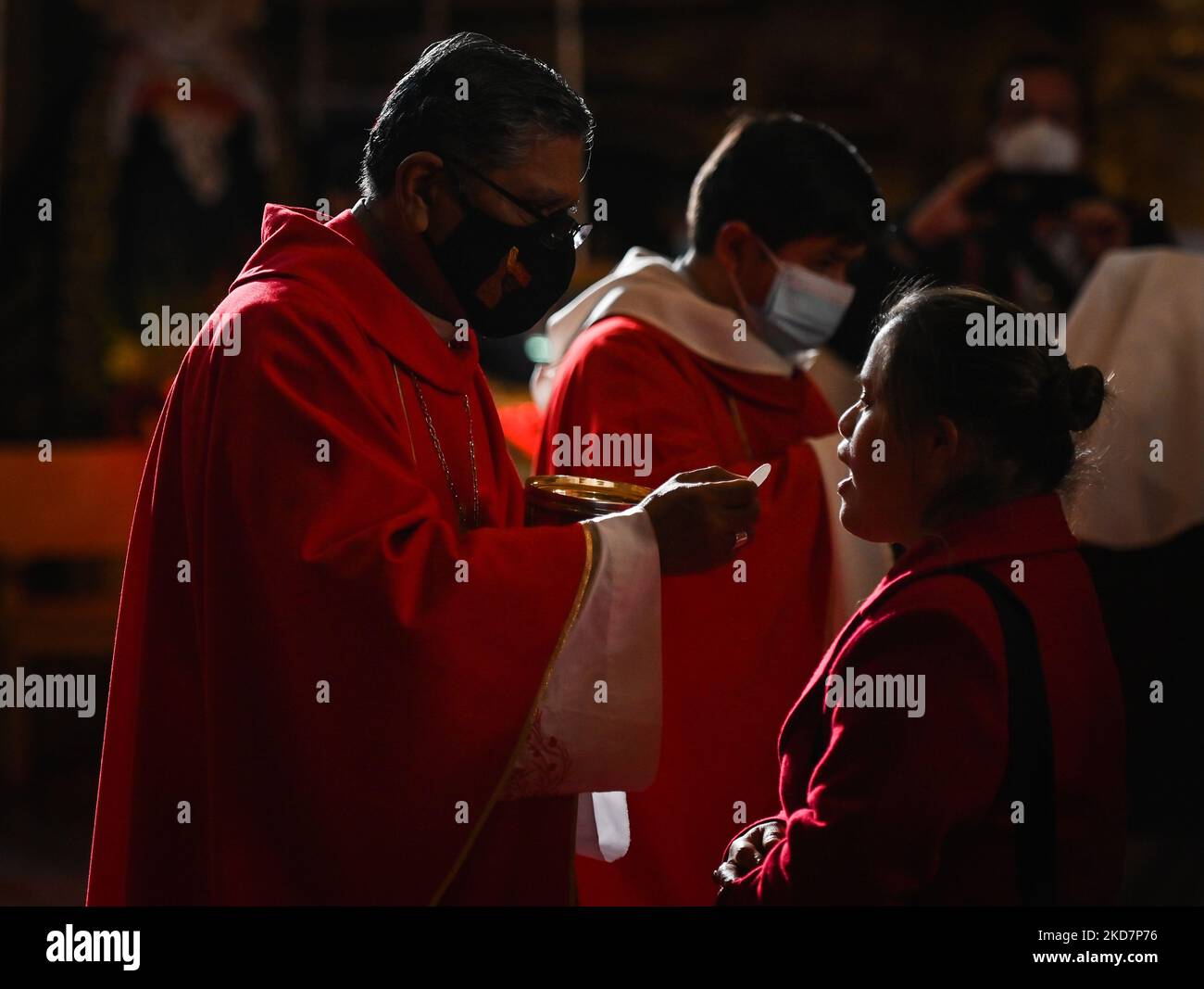 of Cusco, Richard Daniel Alarcón Urrutia (L), gives Holy