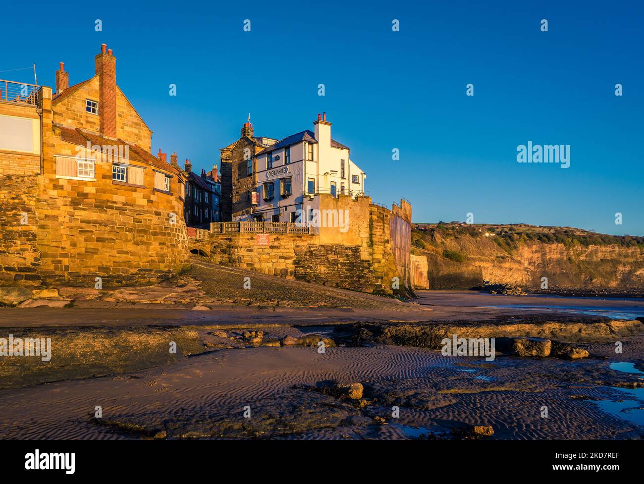 Robin Hoods Bay from the beach at low tide. This is the start / finish of the Coast-to-Coast Walk. This seaside village is popular with holidaymakers. Stock Photo