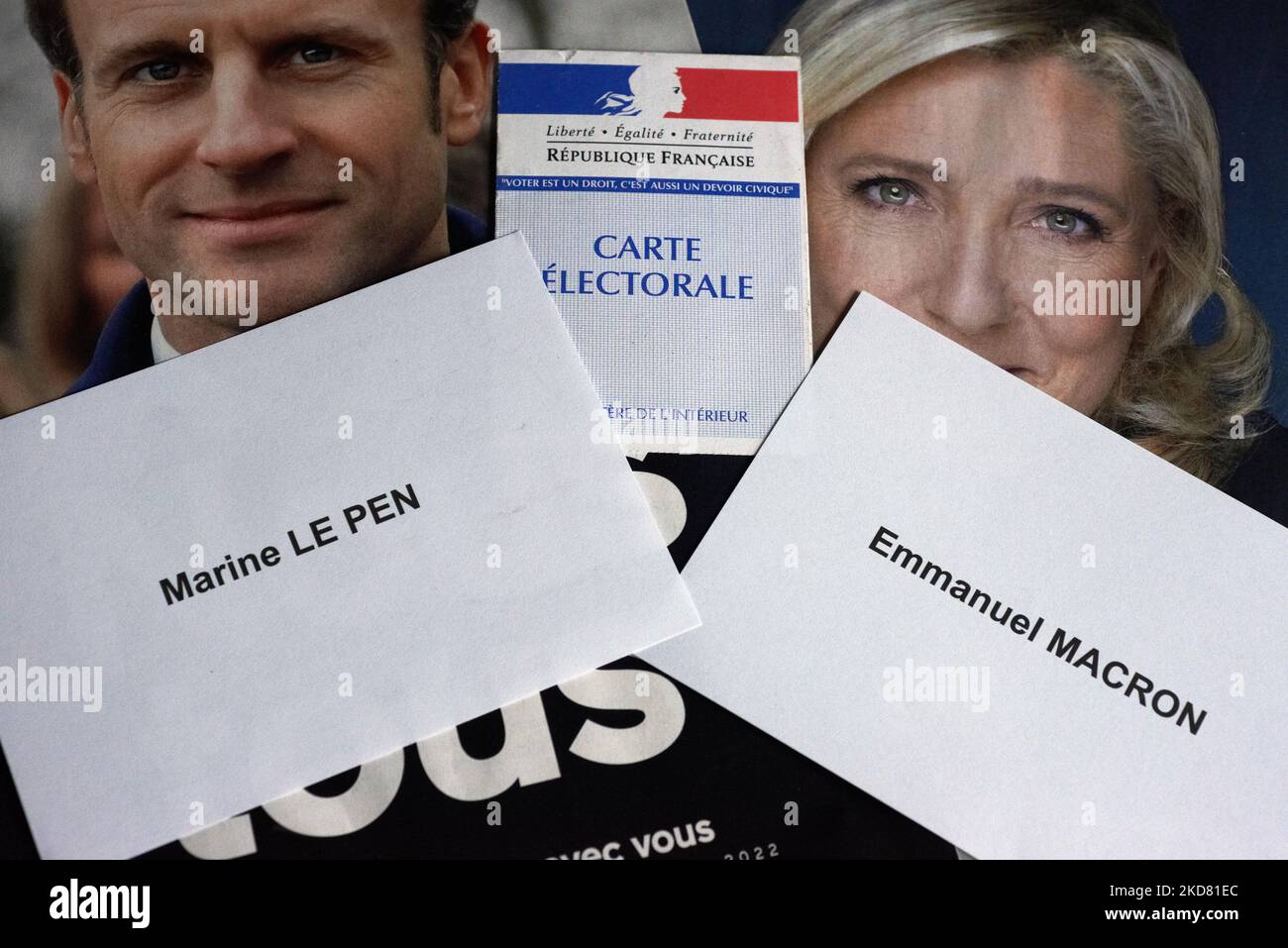 Ballot papers for Macon and Le Pen with a voter card on their programs. Many french voters are undecided for their vote on Sunday 24th April between Emmanuel Macron (current president - right) and Marine Le Pen (far right) for the 2nd round of the French presidential election. Left voters hesitate between Macron, abstention and a blank ballot. Some right voters also don't know for whom they will vote if they don't vote blank or will be abstentionnnists. For now Macron is the favourite to win this election for a 2nd mandate if pollsters are right. Marine Le Pen stands near 48%. Toulouse. France Stock Photo