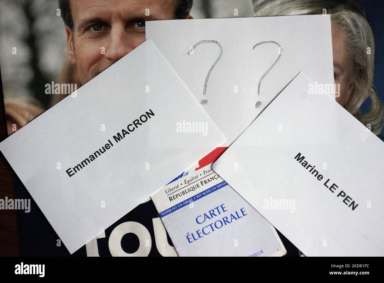 A voter card on candidates'programs with ballot papers for Macron and Le Pen. Many french voters are undecided for their vote on Sunday 24th April between Emmanuel Macron (current president - right) and Marine Le Pen (far right) for the 2nd round of the French presidential election. Left voters hesitate between Macron, abstention and a blank ballot. Some right voters also don't know for whom they will vote if they don't vote blank or will be abstentionnnists. For now Macron is the favourite to win this election for a 2nd mandate if pollsters are right. Marine Le Pen stands near 48%. Toulouse.  Stock Photo