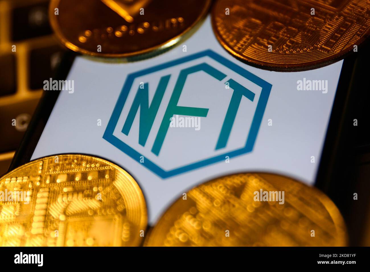 NFT logo displayed on a phone screen and representation of cryptocurrencies are seen in this illustration photo taken in Krakow, Poland on April 19, 2022. (Photo by Jakub Porzycki/NurPhoto) Stock Photo
