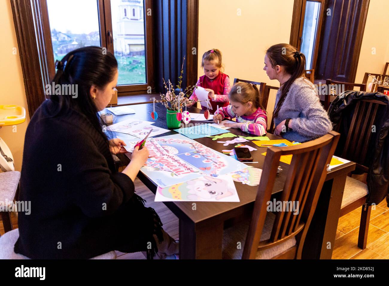 Ukrainian volunteer Krystyna prepares Easter decorations with domestic refugees who escaped from Kharkiv area to relative safety of Nadyby, Lviv Oblast, Ukraine on April 21, 2022. Since the Russian Federation invaded Ukraine, the conflict forced over 10 million people to flee their homes, both internally and externally. Greek-Catholic Church in Nadyby near Lviv hosts dozens of mothers with children who fled the war in eastern part of Ukraine and supports many more refugees in the area. The families found shelter in the Center for the Pastoral Care of Priests and Monks in Nadyby. (Photo by Domi Stock Photo