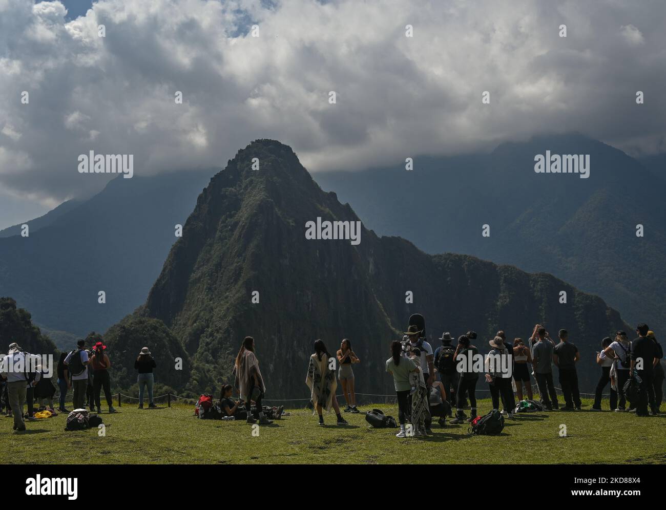 Tourists take pictures of the ancient Inca city of Machu Picchu located in the Andes at an altitude of 2,430 meters (7,970 feet). The most famous icon of the Inca civilization was declared a Peruvian Historical Sanctuary in 1981, a UNESCO World Heritage Site in 1983, and in 2007 was then declared one of the Seven New Wonders of the World. On Wednesday, 20 April 2022, in Historic Sanctuary of Machu Picchu, Urubamba Province, Peru. (Photo by Artur Widak/NurPhoto) Stock Photo