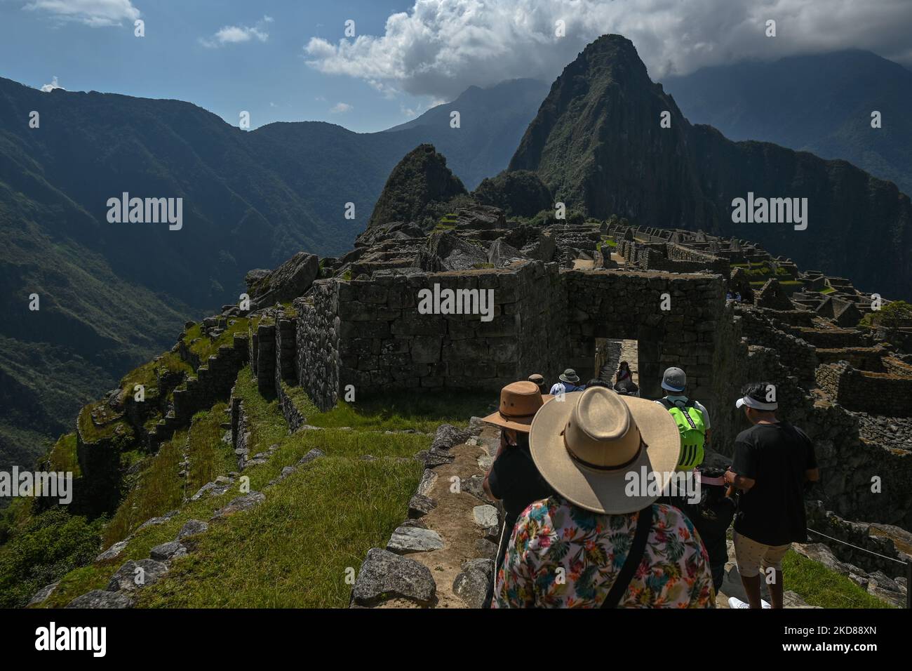 Tourists explore the ancient Inca city of Machu Picchu located in the Andes at an altitude of 2,430 meters (7,970 feet). The most famous icon of the Inca civilization was declared a Peruvian Historical Sanctuary in 1981, a UNESCO World Heritage Site in 1983, and in 2007 was then declared one of the Seven New Wonders of the World. On Wednesday, 20 April 2022, in Historic Sanctuary of Machu Picchu, Urubamba Province, Peru. (Photo by Artur Widak/NurPhoto) Stock Photo