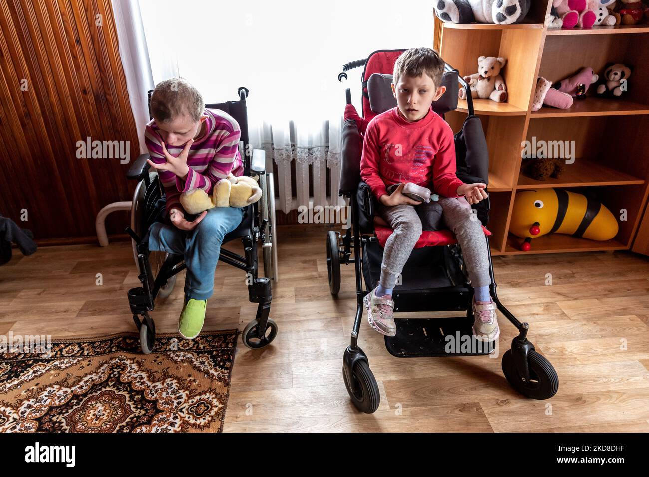 Ukrainian girls with learning disabilities sit in their armchairs as they rest in a common room in a Center for women and girls with learning disabilities run by Greek Catholic church in Bukova, Lviv Oblast Ukraine on April 25, 2022. As the Russian Federation invaded Ukraine two months ago, the conflict caused that places like the Centre in Bukova become even more isolated and underfunded. (Photo by Dominika Zarzycka/NurPhoto) Stock Photo