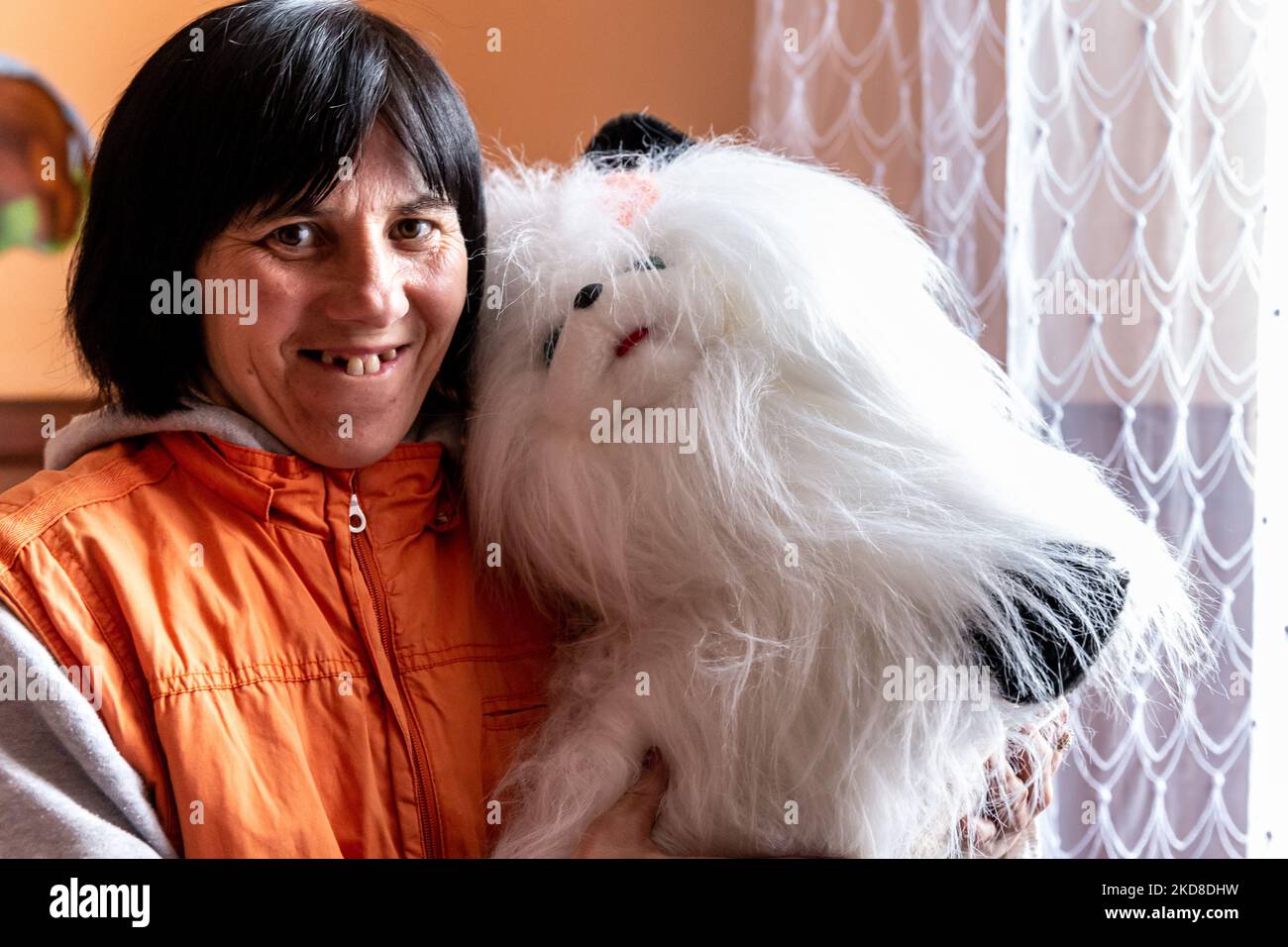 A Ukrainian woman with learning disabilities smiles as she rests in a common room in a Center for women and girls with learning disabilities run by Greek Catholic church in Bukova, Lviv Oblast Ukraine on April 25, 2022. As the Russian Federation invaded Ukraine two months ago, the conflict caused that places like the Centre in Bukova become even more isolated and underfunded. (Photo by Dominika Zarzycka/NurPhoto) Stock Photo