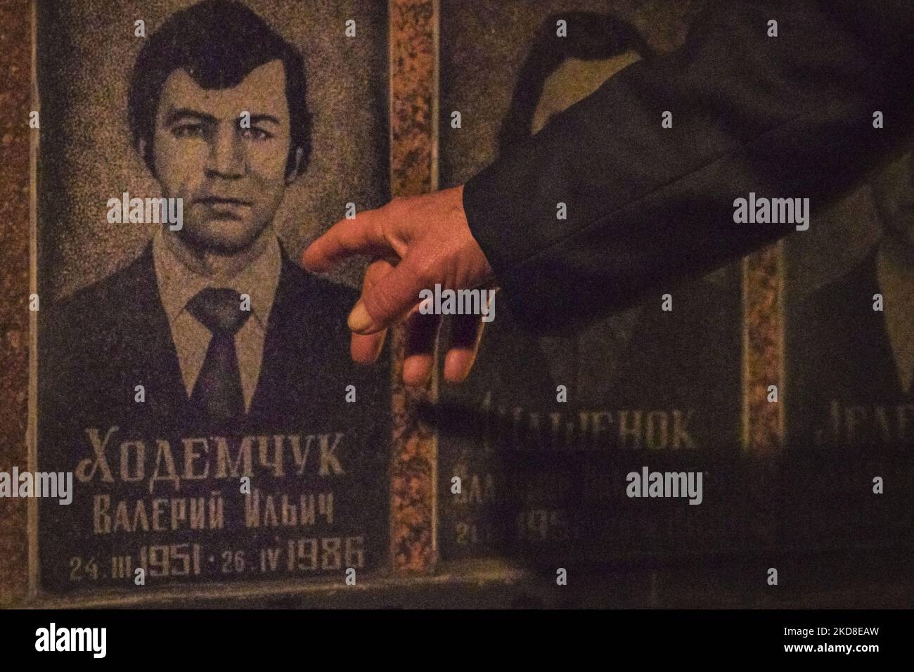 A visitor points to a relative in the memorial of the dead workers in ...