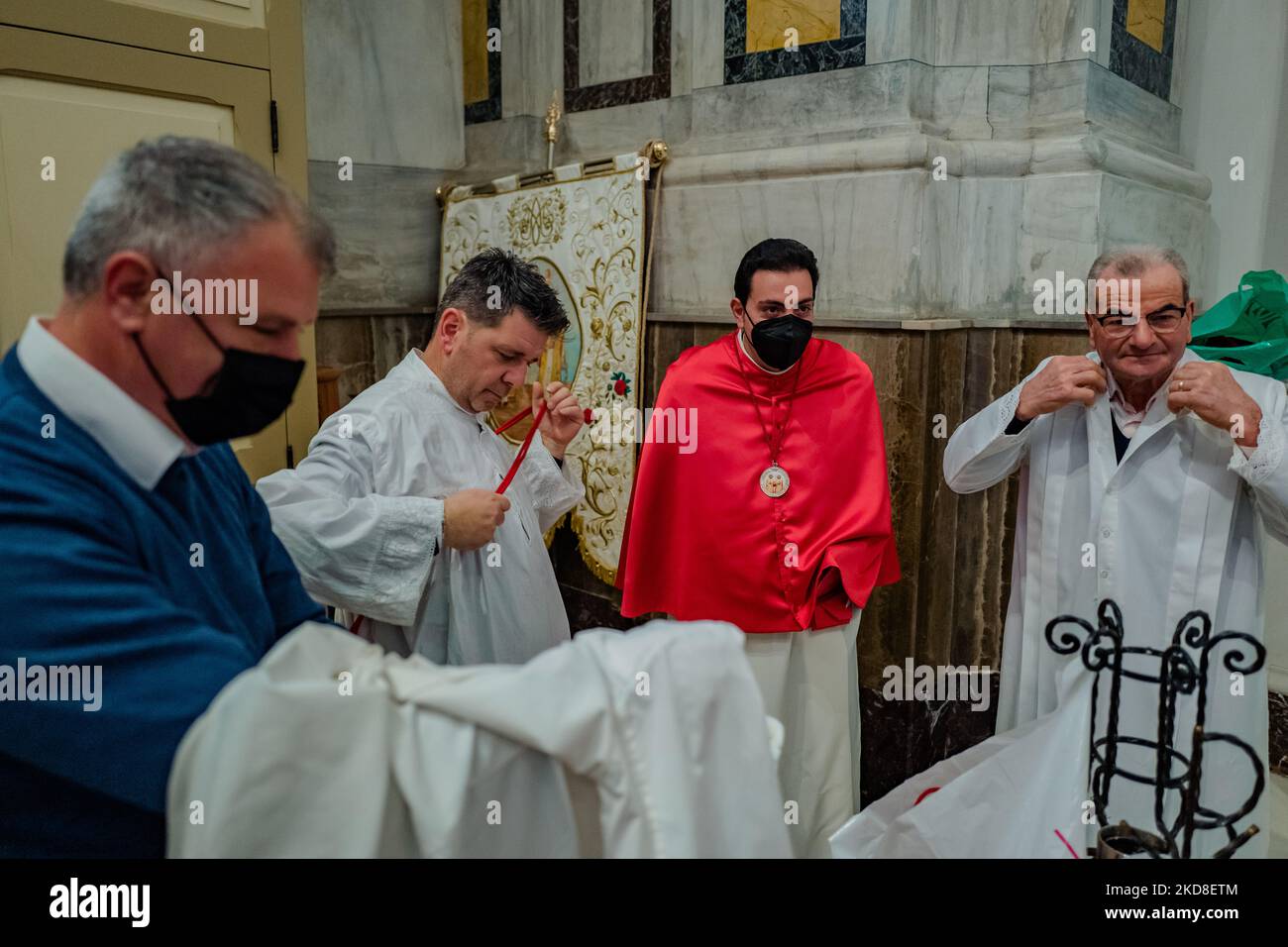 Members of the brotherhood perform the dressing before carrying the icon of the Madonna of Sovereto in procession in the Concattedrale of Terlizzi on April 23, 2022. After two years of pandemic, the feast dedicated to Our Lady of Sovereto in Terlizzi is back. The celebrations were held on Saturday 23 April paying homage to Maria SS. of Sovereto. The morning was dedicated to religious celebrations which saw their central moment in the solemn pontifical which was officiated in the Co-Cathedral by the bishop Mons. Domenico Cornacchia; the Holy Mass was followed by the long procession which ended  Stock Photo