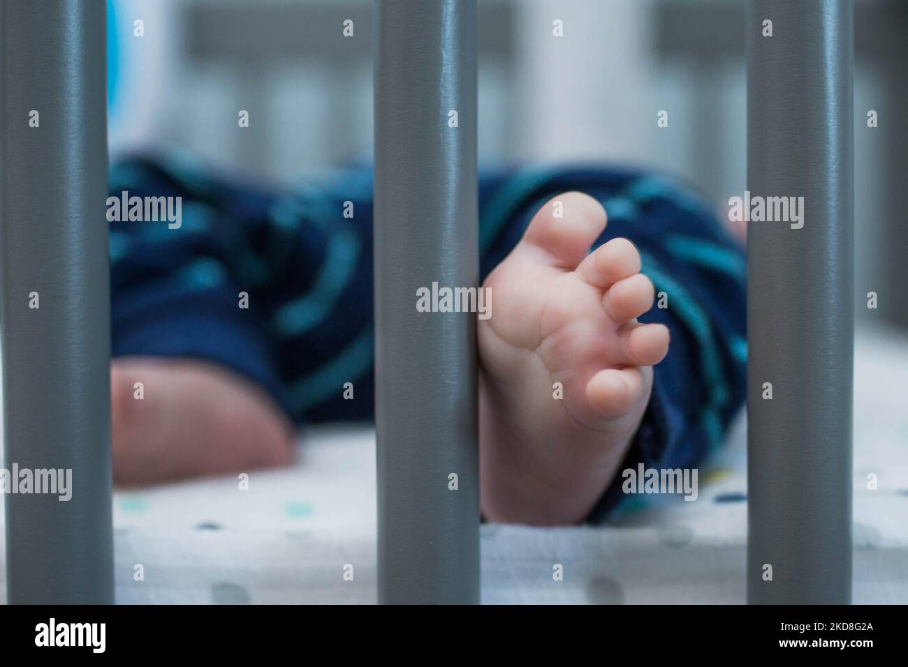 A newborn baby sleeping in a cot Stock Photo Alamy