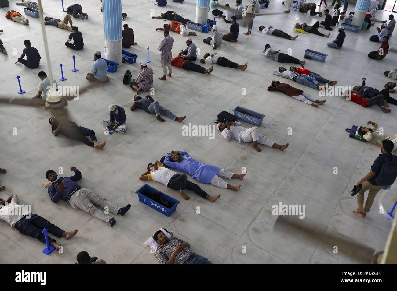 Exhausted Muslim lye down on the mosque floor as they are fasting