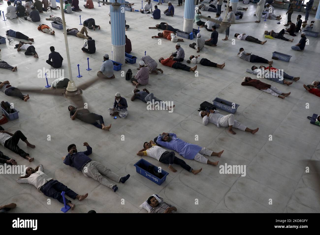 Exhausted Muslim lye down on the mosque floor as they are fasting