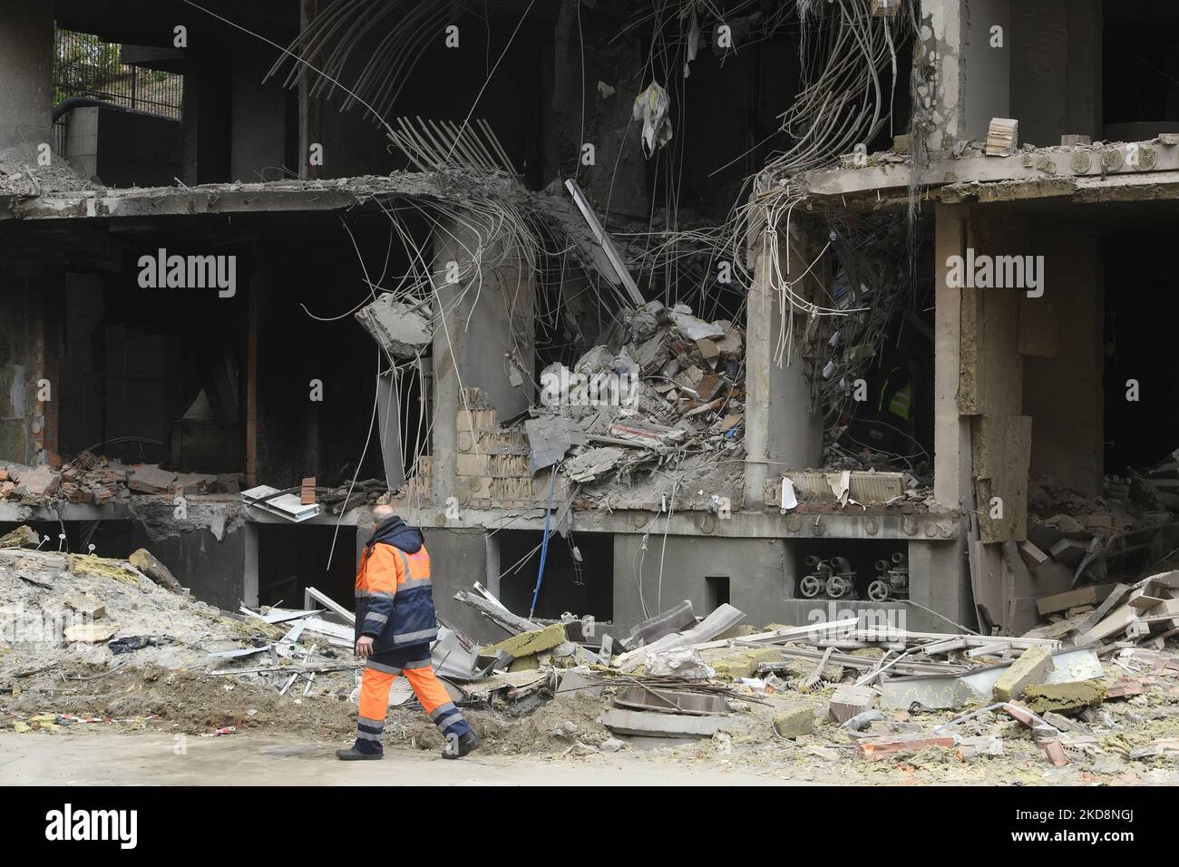 Rescuer walks near apartment block destroyed in a rockets shelling ...