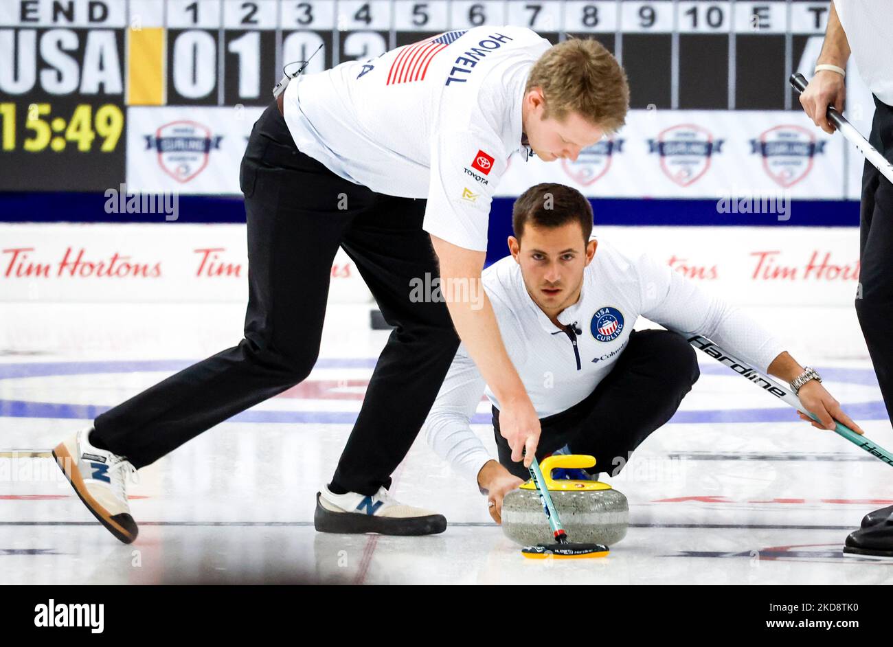 United States skip Korey Dropkin, right, and as lead Thomas Howell sweeps during semi-final playoff action against Korea at the Pan Continental Curling Championships in Calgary, Alta., Saturday, Nov