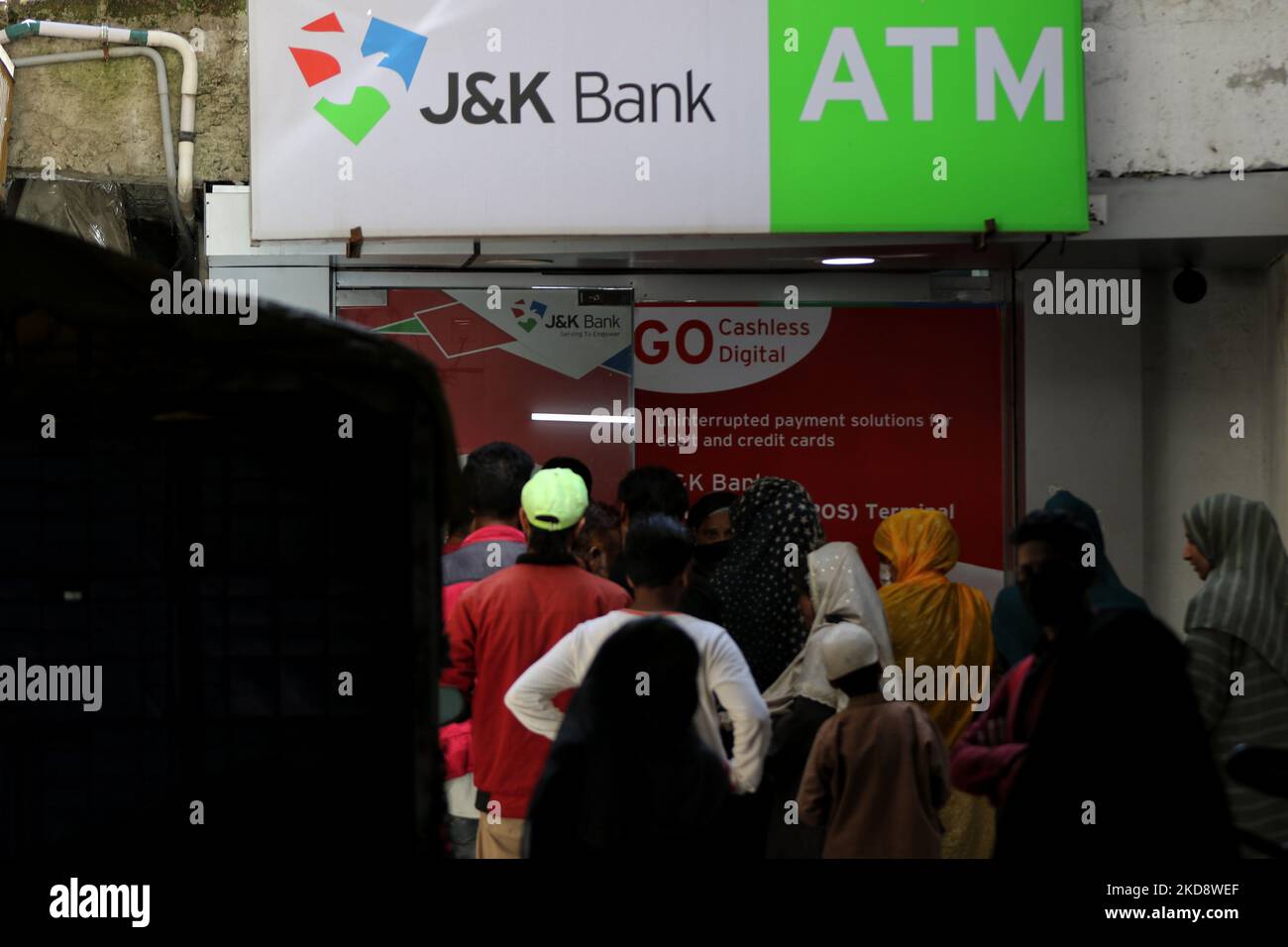 People are seen in a queue outside a Jammu and Kashmir Bank's JK Bank