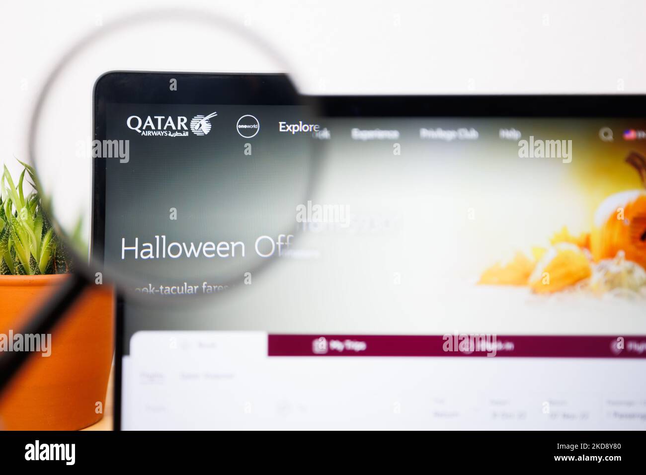 The Qatar Airways Logo under a magnifying glass. Qatar Airways site