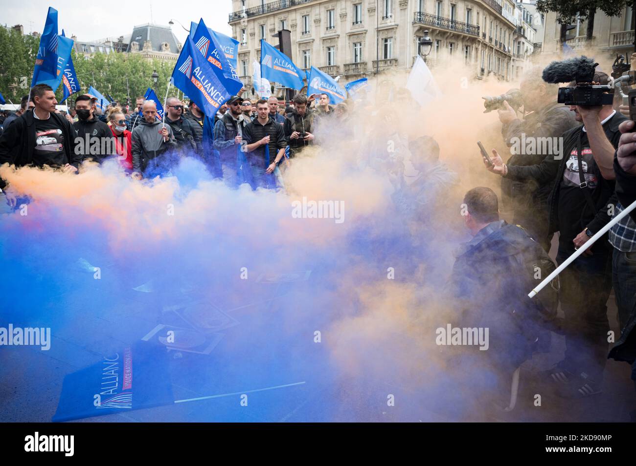 Police officers stand behind a cloud of blue and orange smoke during a police demonstration in Paris on May 2, 2022 to protest the indictment for 'voluntary manslaughter' of the French police officer who killed two men who allegedly forced a checkpoint on the Pont-Neuf in Paris on April 24, 2022. The call for the rally was initiated by the Alliance Police Nationale union, which was joined by the Synergie officers' union and Unsa-Police. (Photo by Samuel Boivin/NurPhoto) Stock Photo