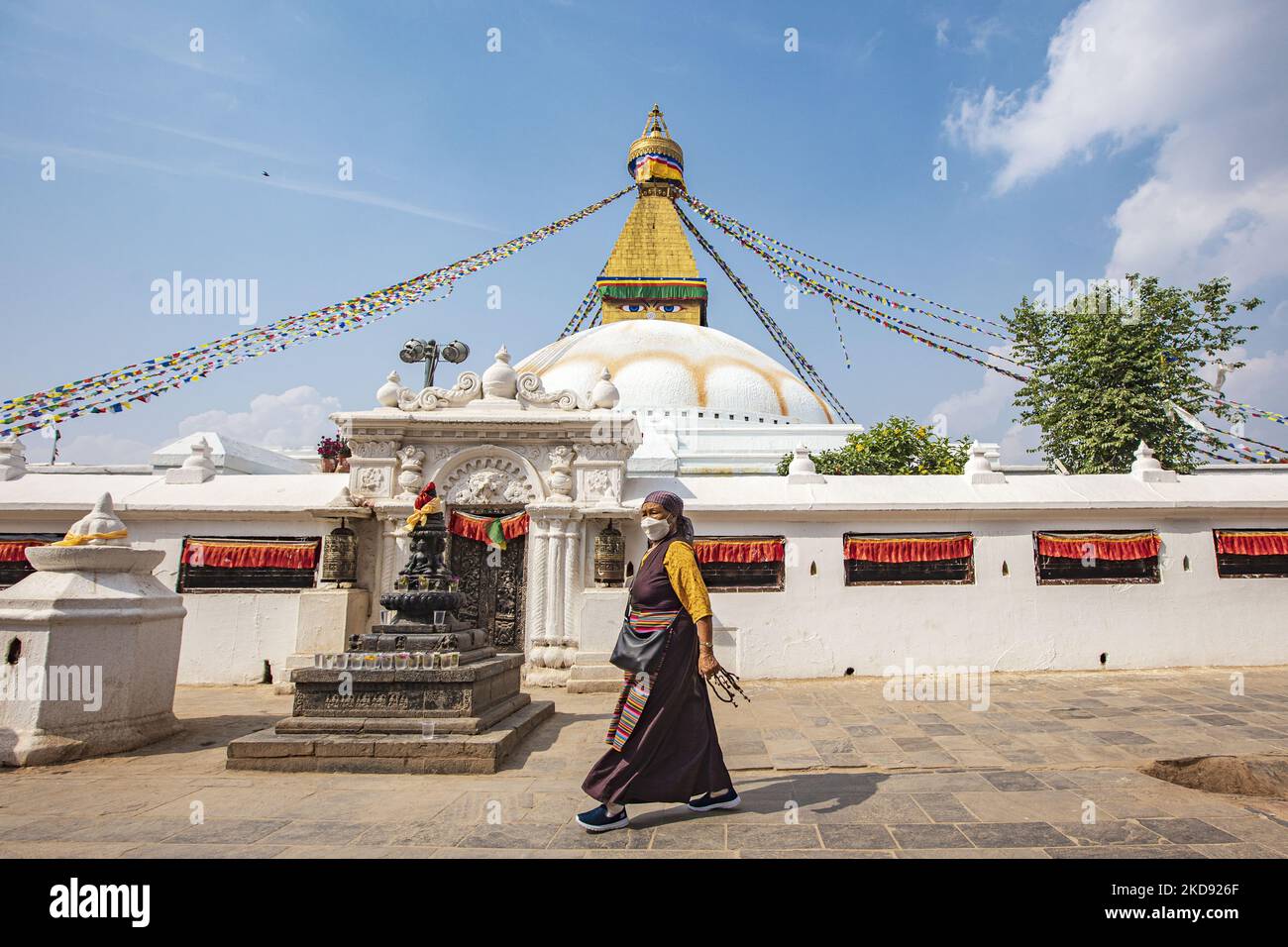 A woman doing the Kora, walking around the stupa. Boudhanath or Bouddha