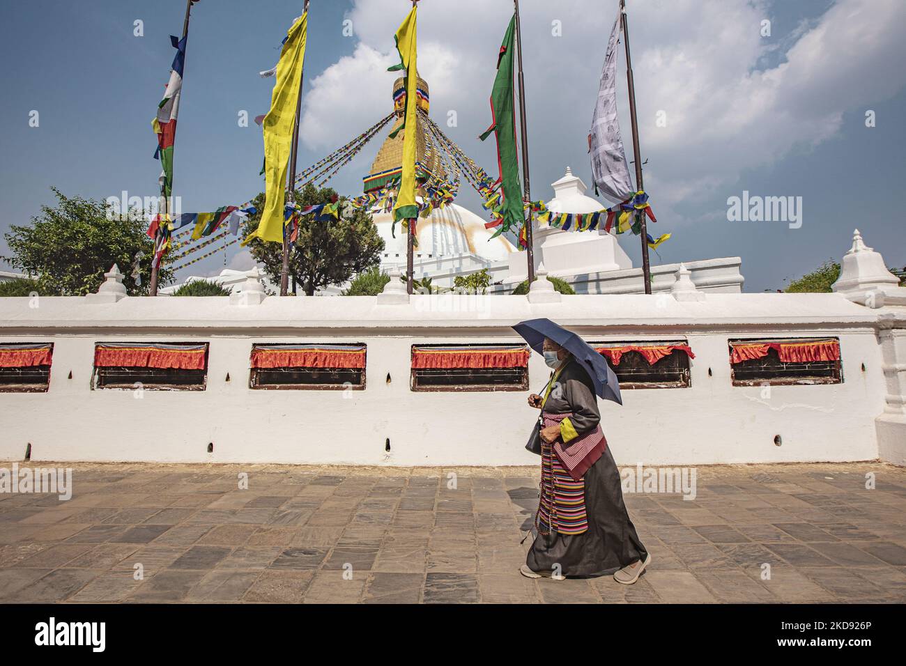 A woman doing the Kora, walking around the stupa. Boudhanath or Bouddha
